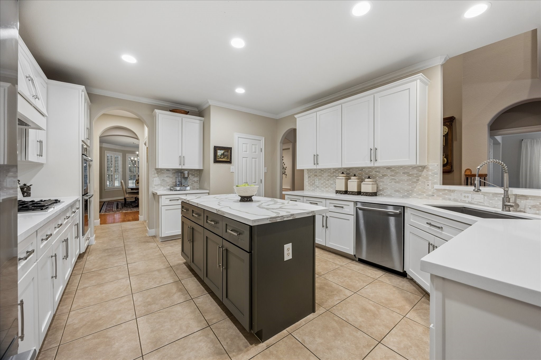Features gas cooktop, double ovens, and ample counter and storage space.