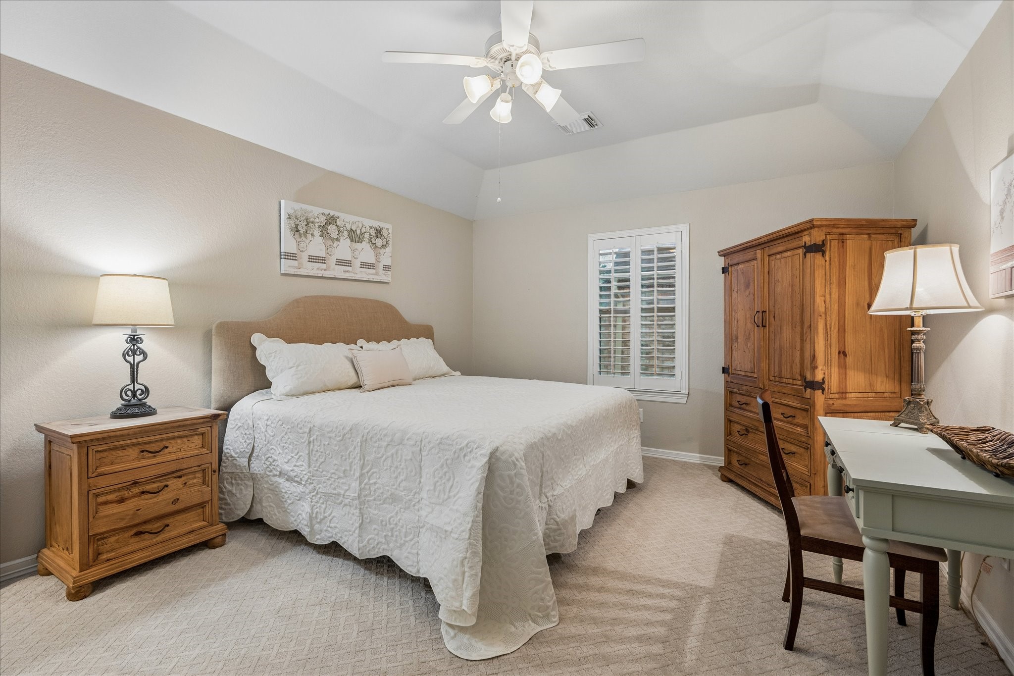 Bedroom 3 has a vaulted ceiling, plantation shutters, and connects to the Hollywood bath.