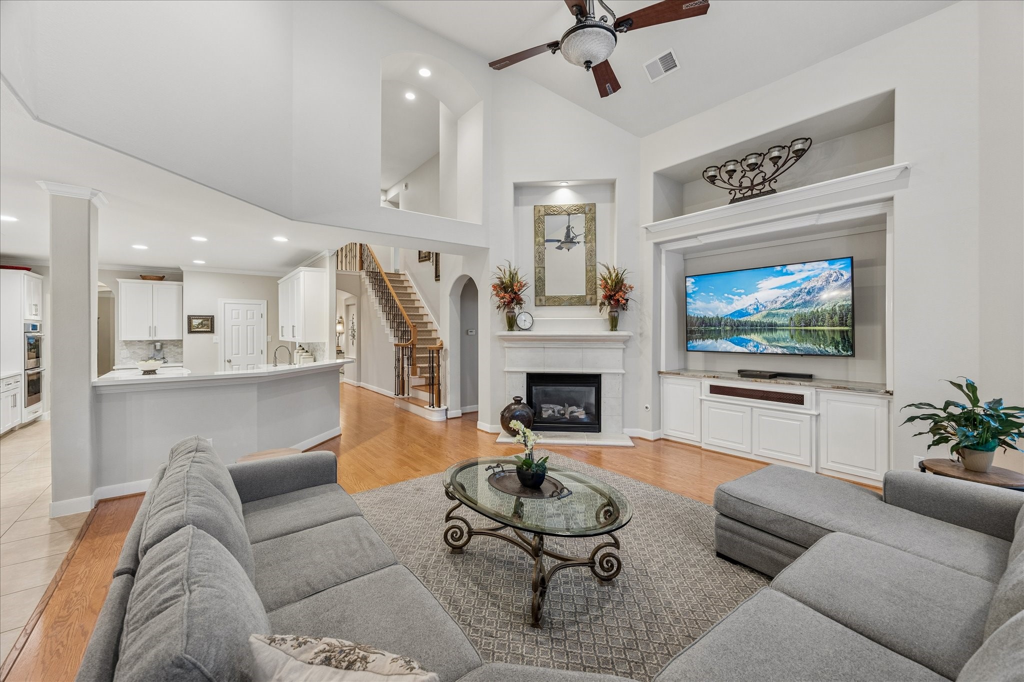 The family room features high ceilings with attractive built-in storage and cast stone gaslog fireplace.