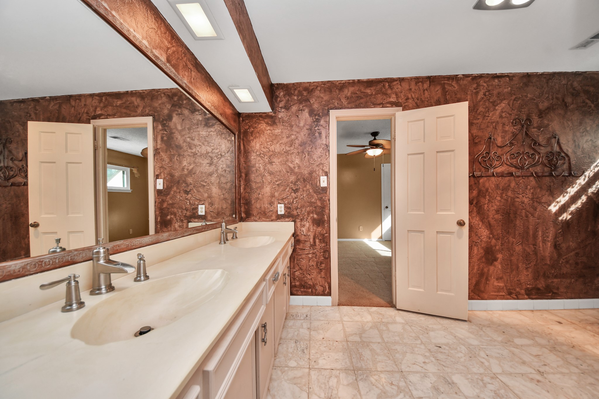 Secondary bath up features a long dual-sink vanity and plenty of counter space.