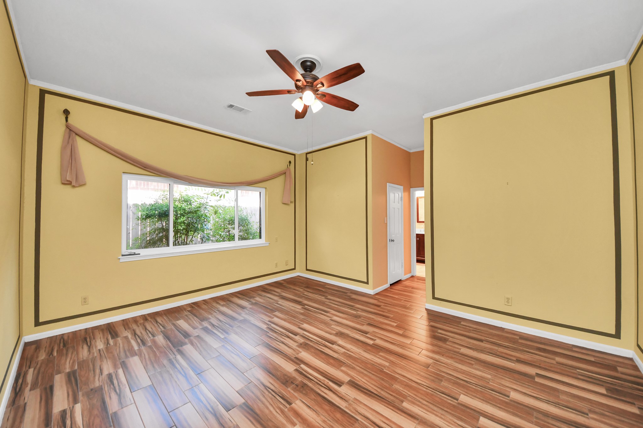 Spacious primary suite offers plenty of room for a king-size bed and additional furnishings.