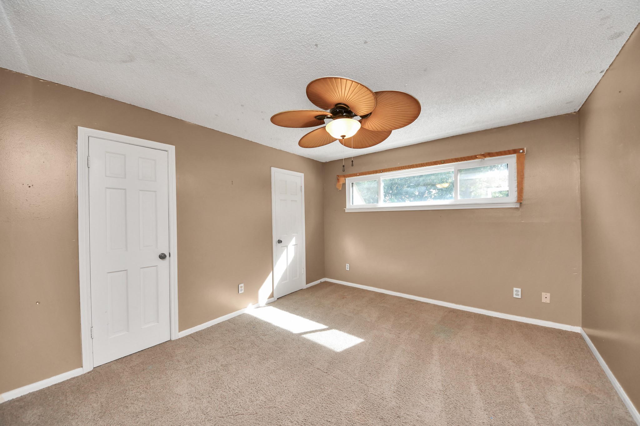 Another spacious secondary bedroom offers two closets and plenty of room for a sitting or study area.