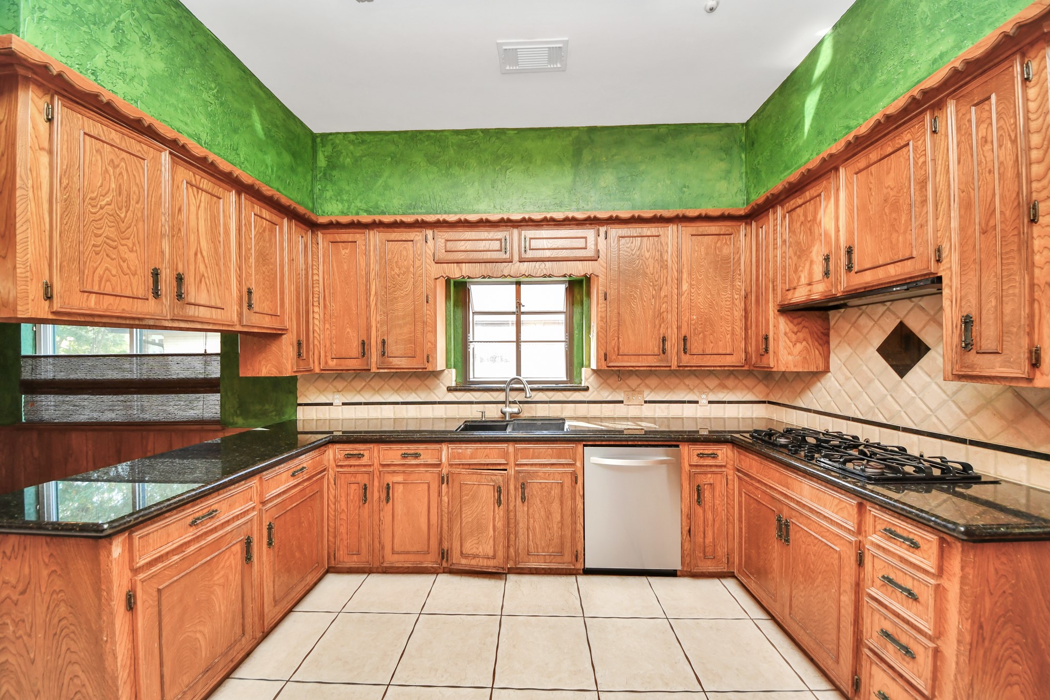 The kitchen offers extensive cabinetry, granite counters and a generous footprint ready for a fresh vision. The kitchen offers extensive cabinetry, granite counters and a generous footprint ready for a fresh vision.
