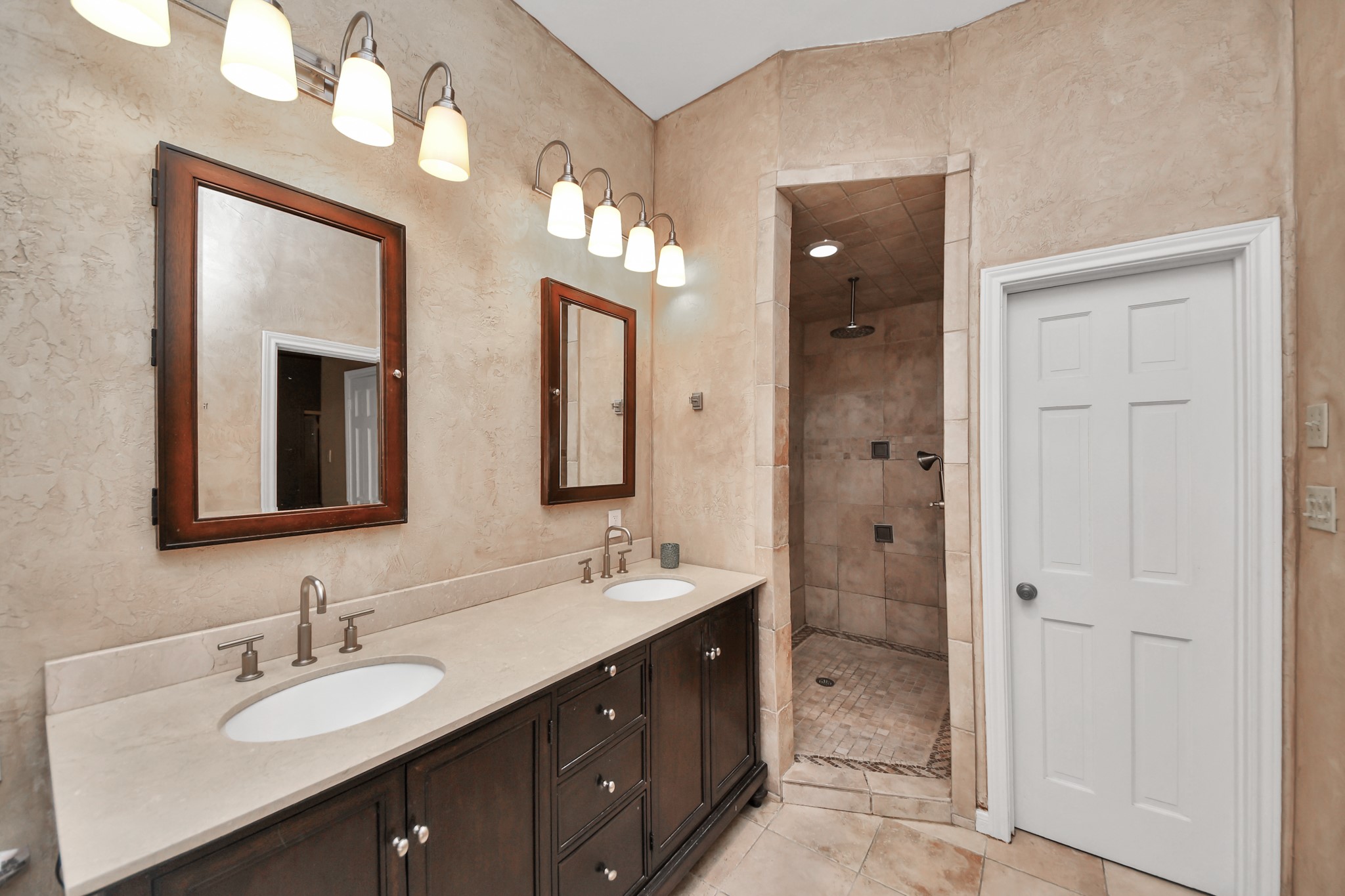 This view highlights the oversized vanity and separate walk-in shower.