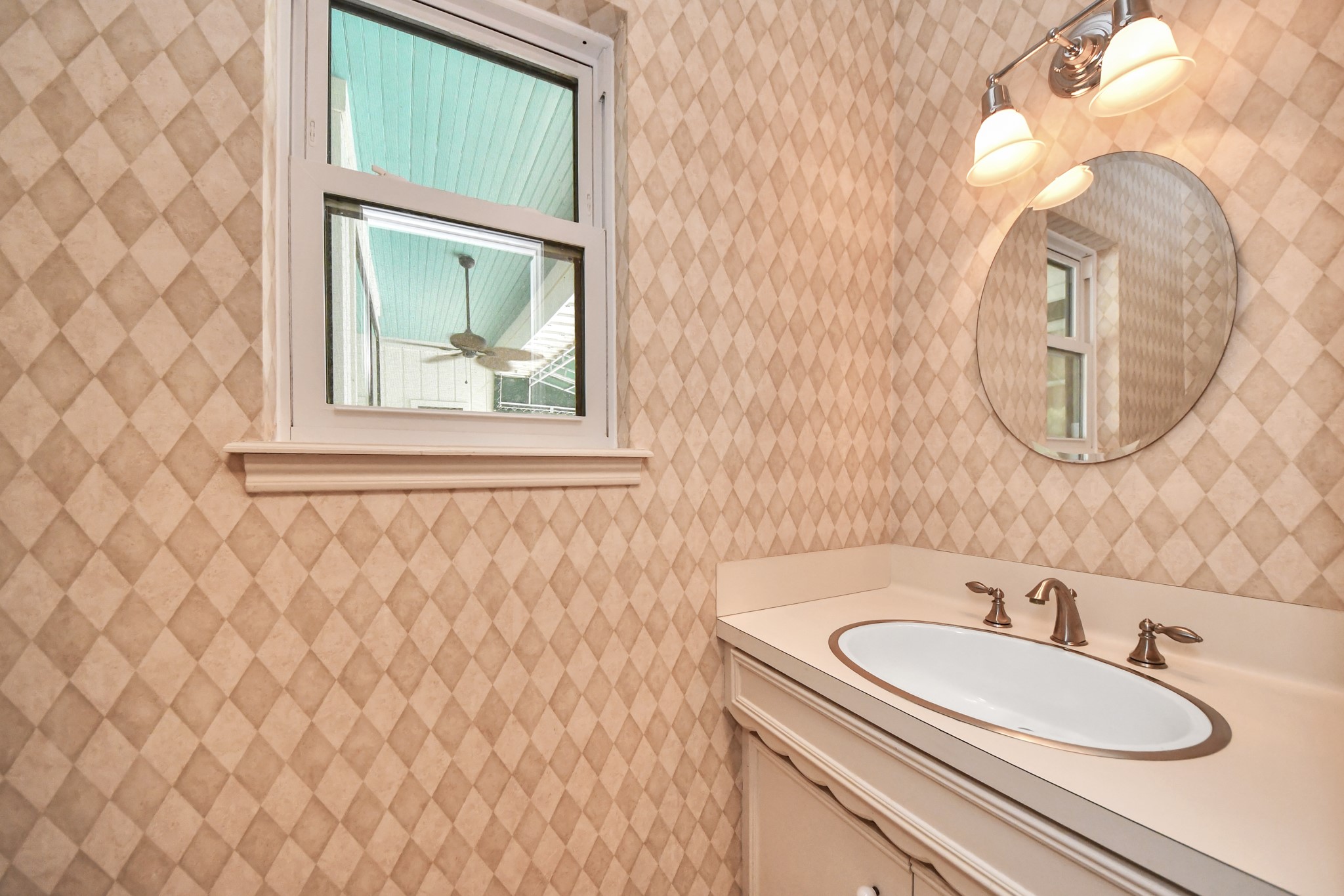 Convenient powder bath serves the main living areas and features a window for natural light. Located near the back door, so easy to use for pool half bath!