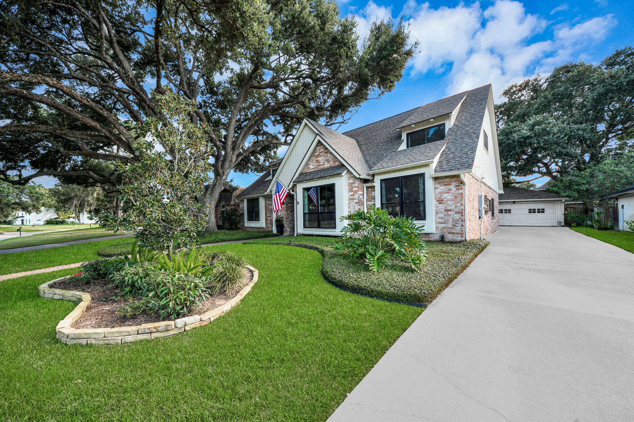 Set beneath beautiful mature trees, this classic home offers great curb appeal, a long driveway and detached garage.
