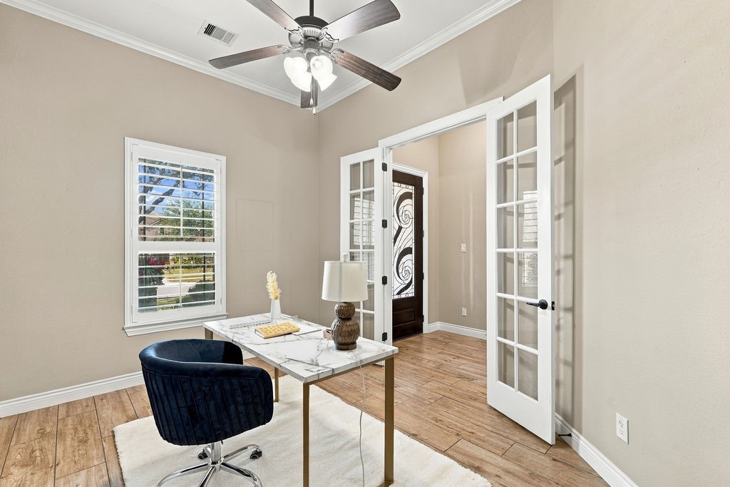Private home office tucked away behind elegant French doors.
