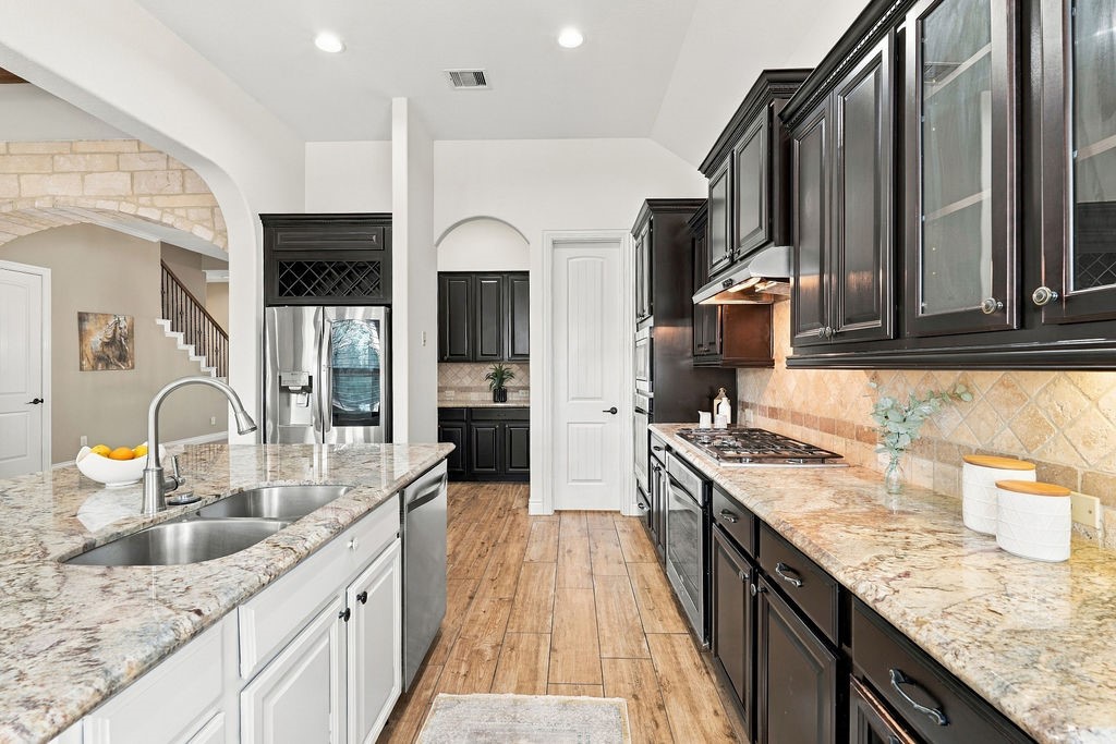 Endless counter space and cabinet storage in this spacious kitchen layout.