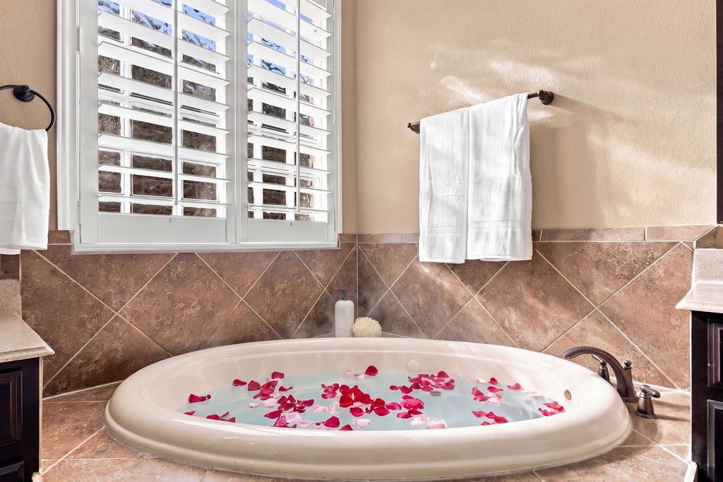 Unwind after a long day in this deep soaking tub tucked right under the window.
