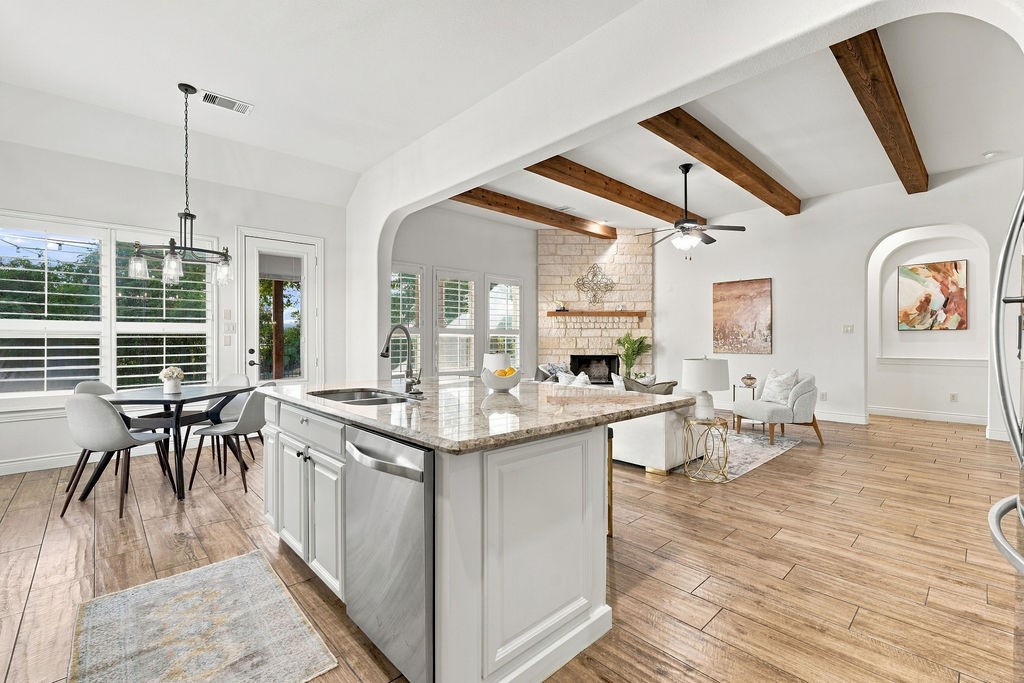 Great view showing how easily the kitchen flows into the casual dining and living areas.