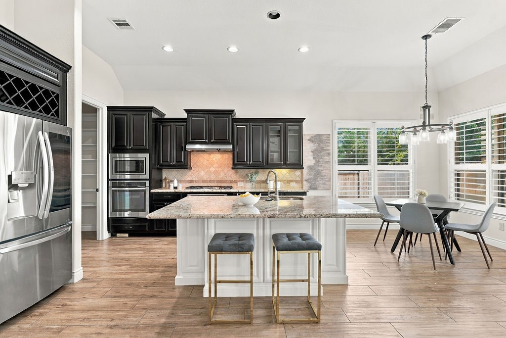 The massive island kitchen features plenty of workspace and is the true heart of this home.