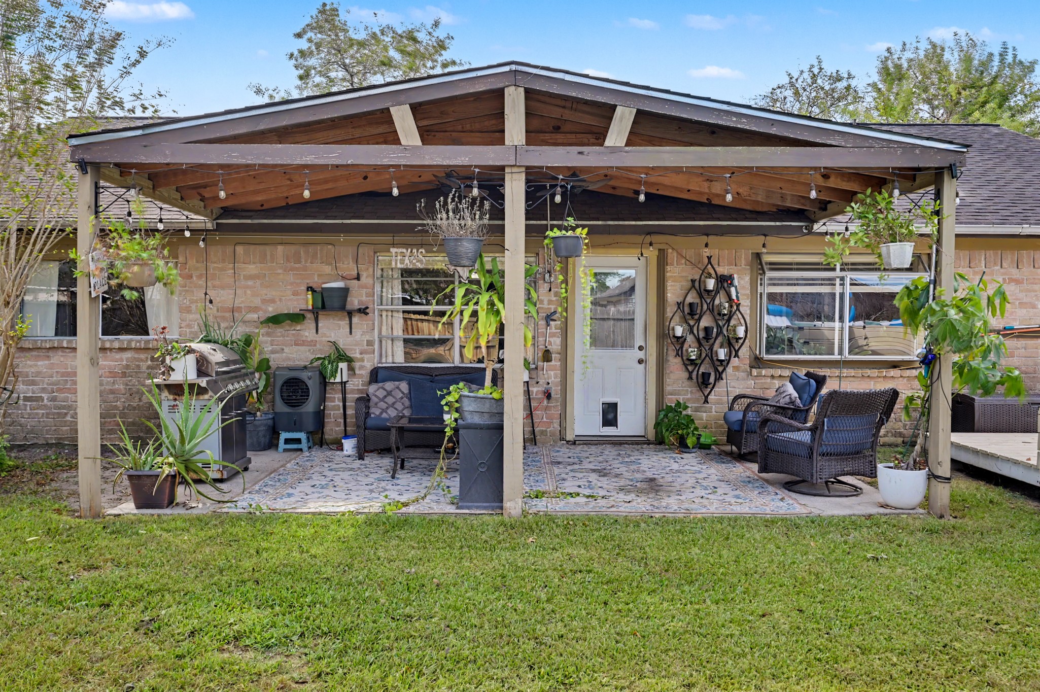 Backyard seating area featuring comfortable lounge space and outdoor views.