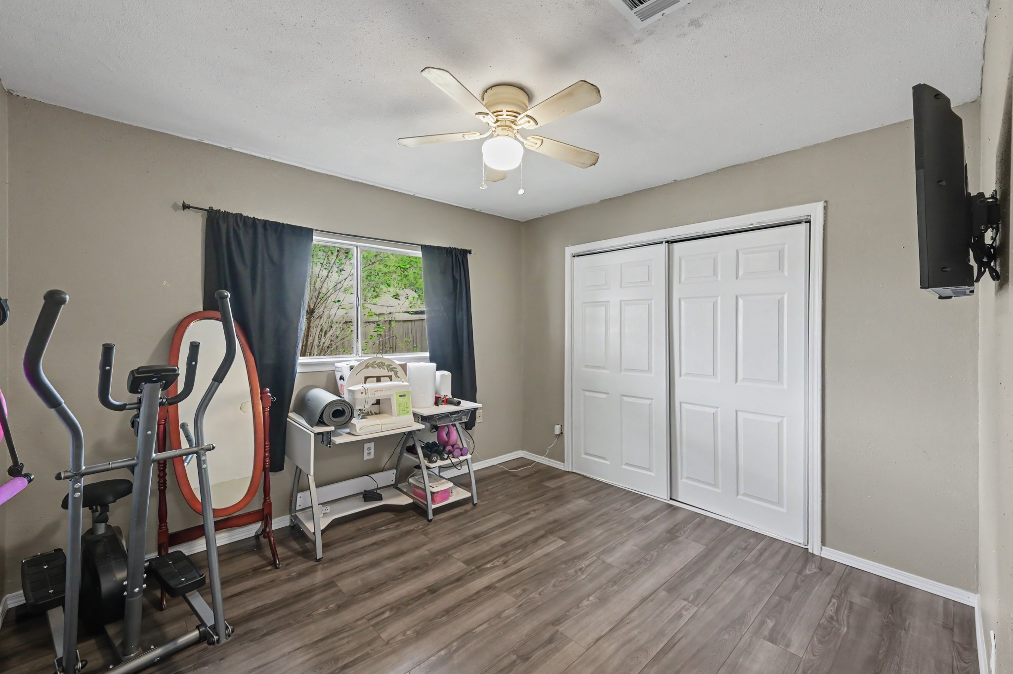 This versatile space can function as a third bedroom or a dedicated home gym/workout area.