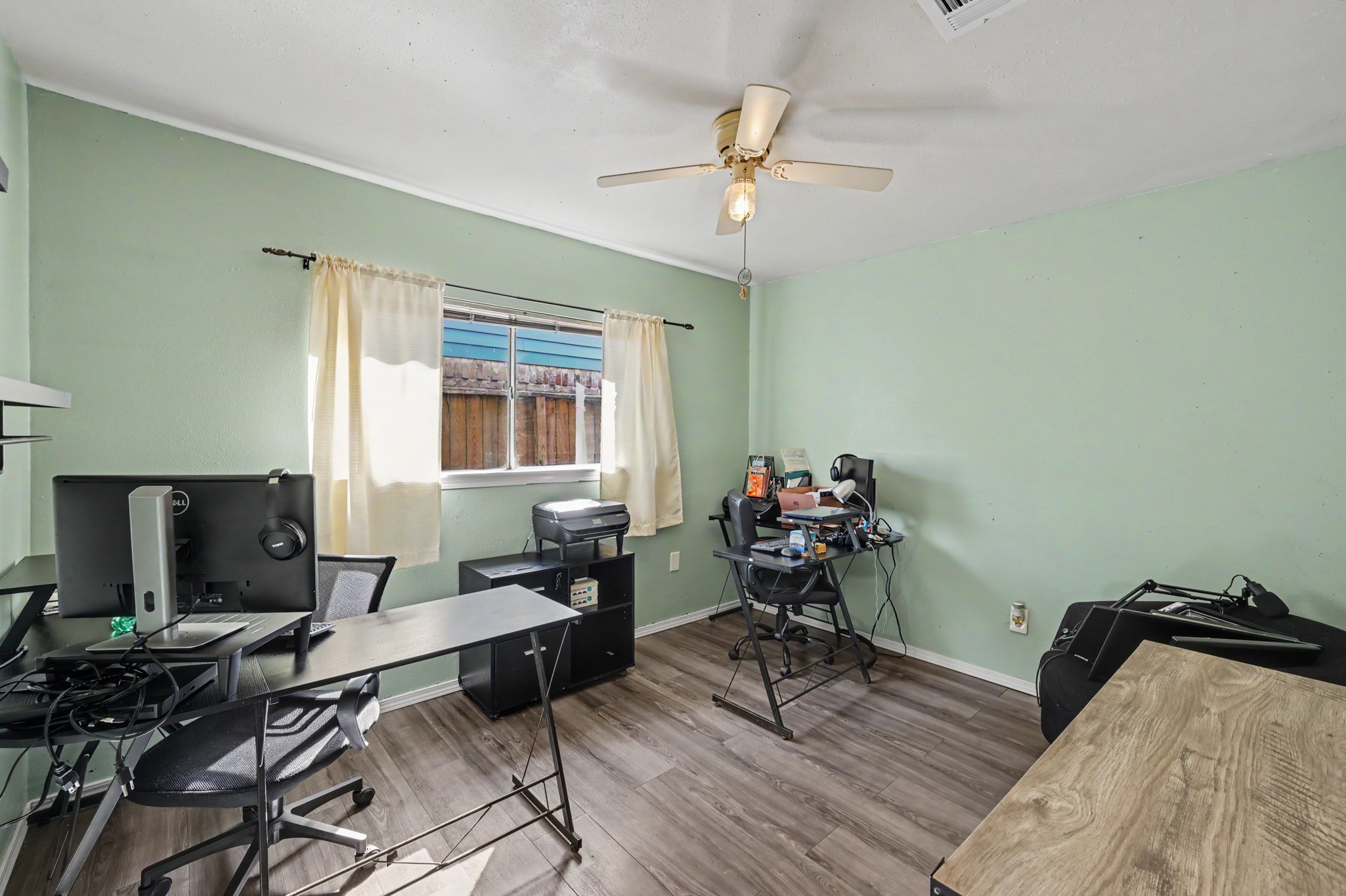 Versatile space currently staged as an office, but it could easily serve as a spare bedroom.