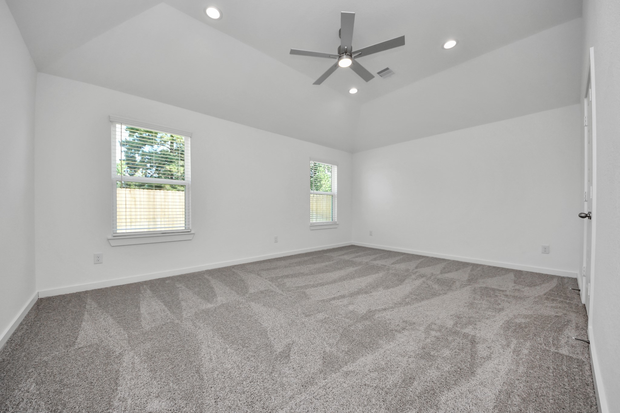 Come and unwind after a long day in this magnificent primary suite! This spacious room features plush carpet, warm paint, high ceilings and large windows with privacy blinds. Sample photo of completed home with similar floor plan. Actual colors and selections may vary.
