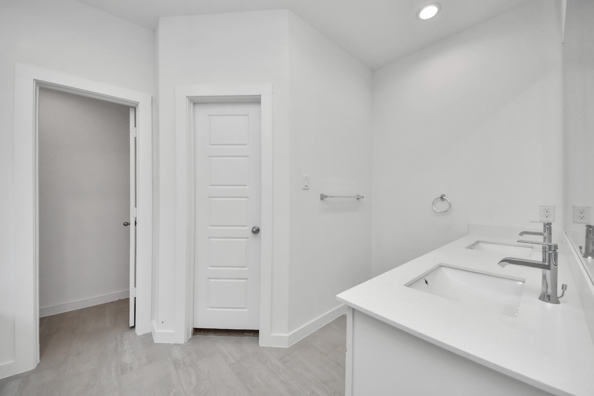 Escape to a spa-like oasis in this primary bathroom. Enjoy a walk-in shower with tile surround, a separate garden tub with custom detailing, and an elegant vanity featuring light countertops, modern hardware, and beautiful recessed lights. Experience luxury and relaxation in every detail. Sample photo of completed home with similar floor plan. Actual colors and selections may vary.