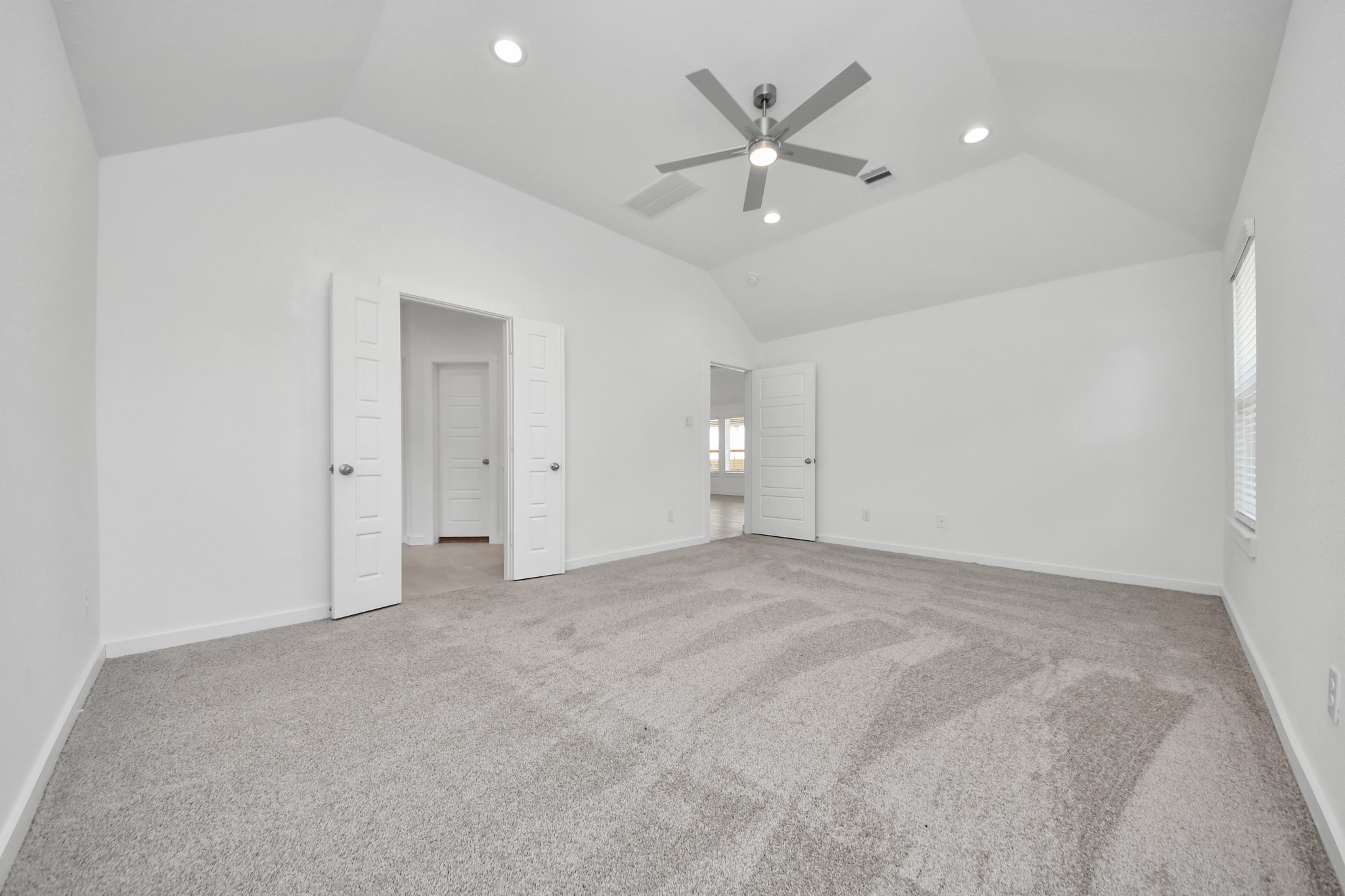 Another perspective unveils a comprehensive view of the serenity and comfort this primary suite offers. Sample photo of completed home with similar floor plan. Actual colors and selections may vary.