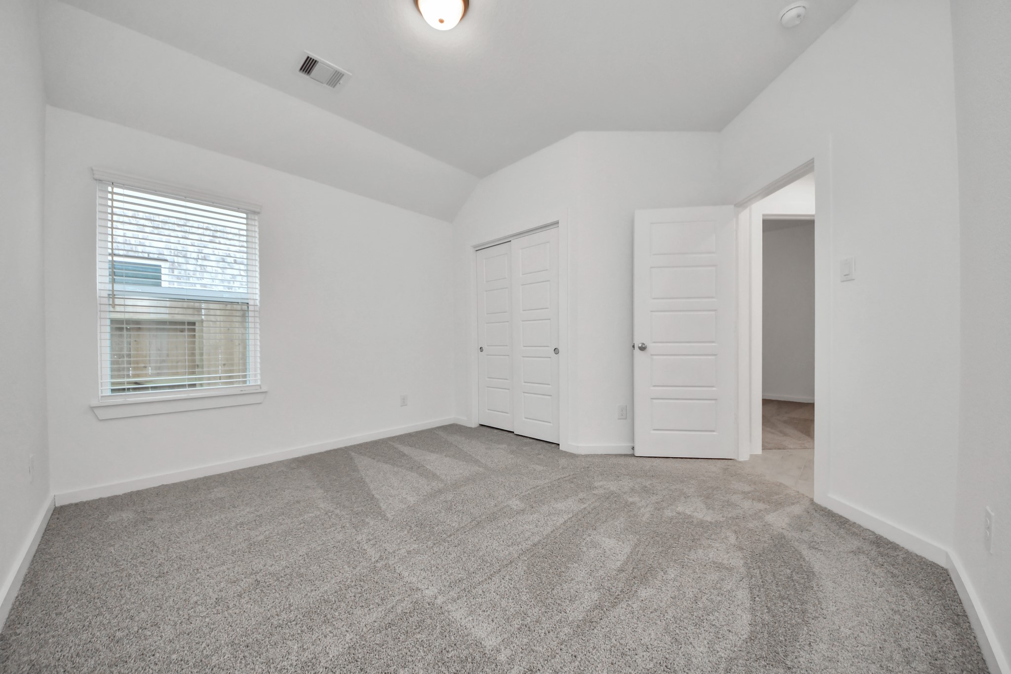 Generously sized secondary bedrooms featuring spacious closets, soft and inviting carpeting underfoot, large windows allowing plenty of natural light, and the added touch of privacy blinds for your personal retreat. Sample photo of completed home with similar floor plan. Actual colors and selections may vary.