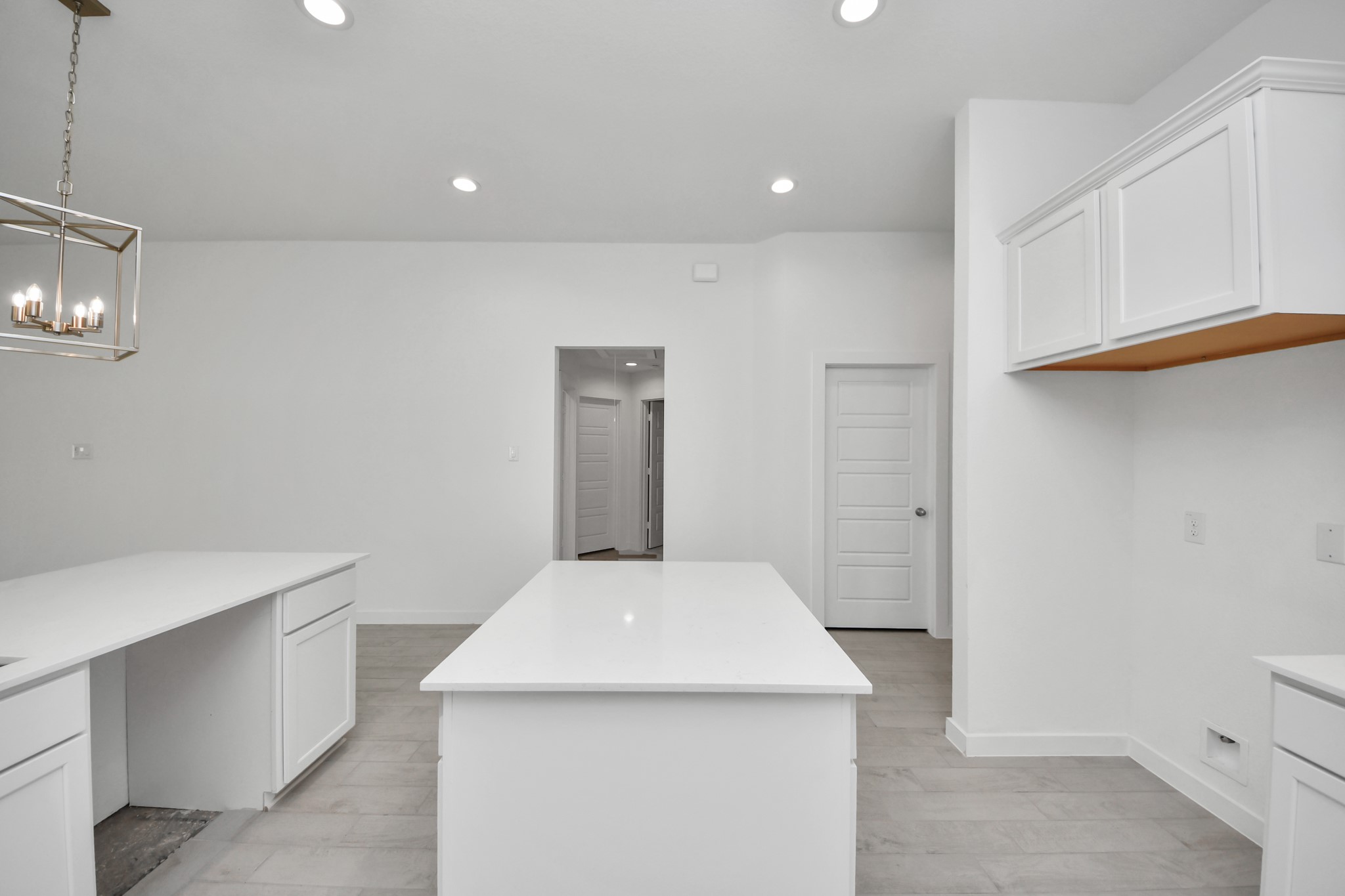 Discover another perspective of this stunning kitchen, generously appointed with an abundance of counter space. Sample photo of completed home with similar floor plan. Actual colors and selections may vary.