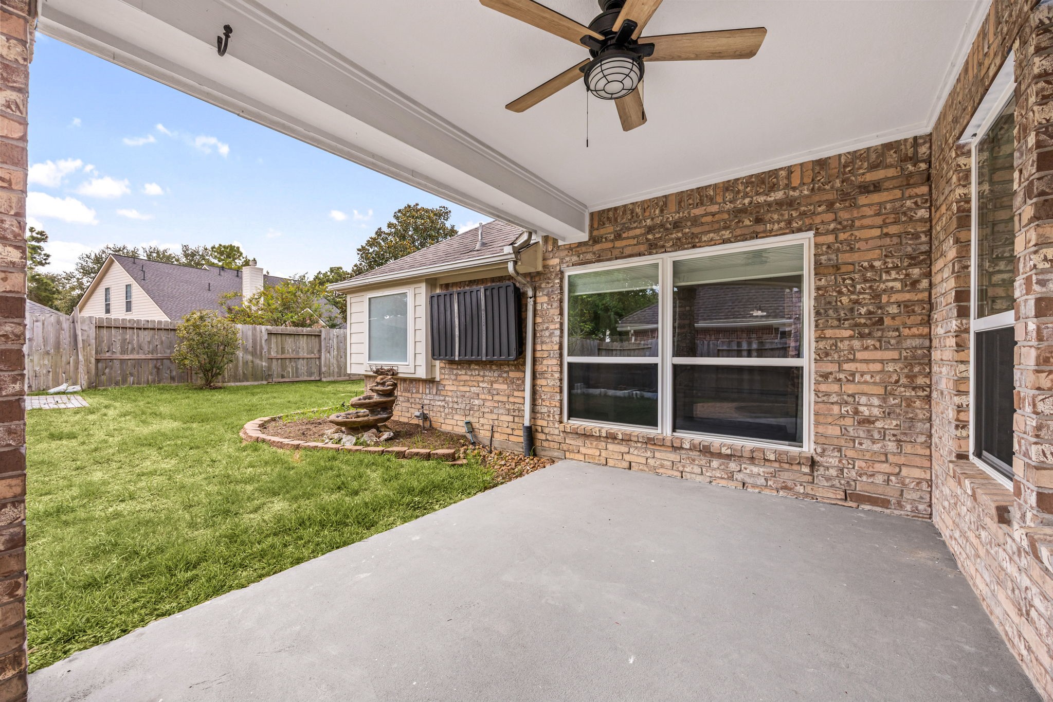 Additional covered patio view overlooking the backyard and providing a shaded space for outdoor relaxation.
