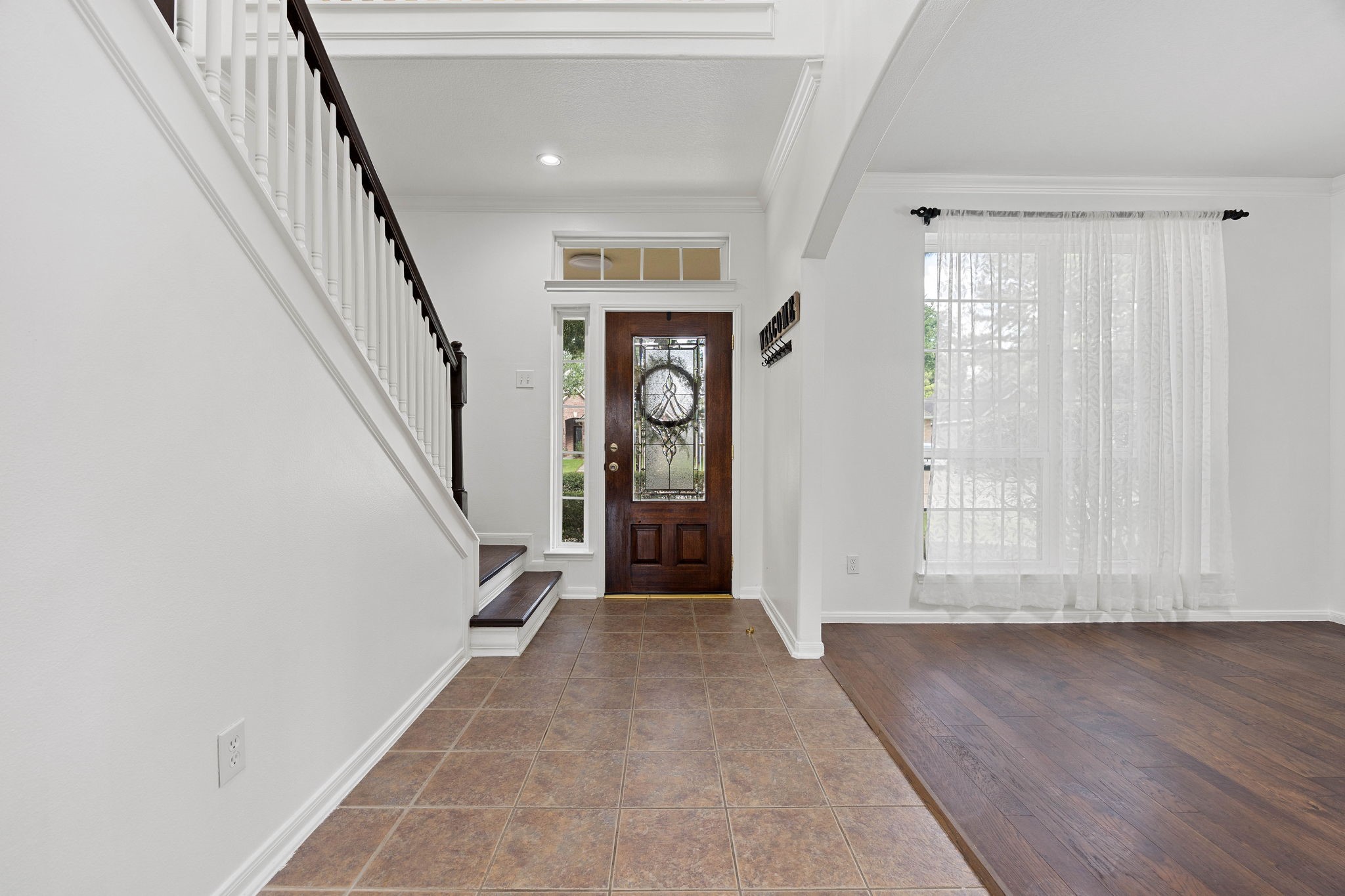 Front entry and foyer offering a bright, open feel with easy access to the adjoining dining and living spaces.