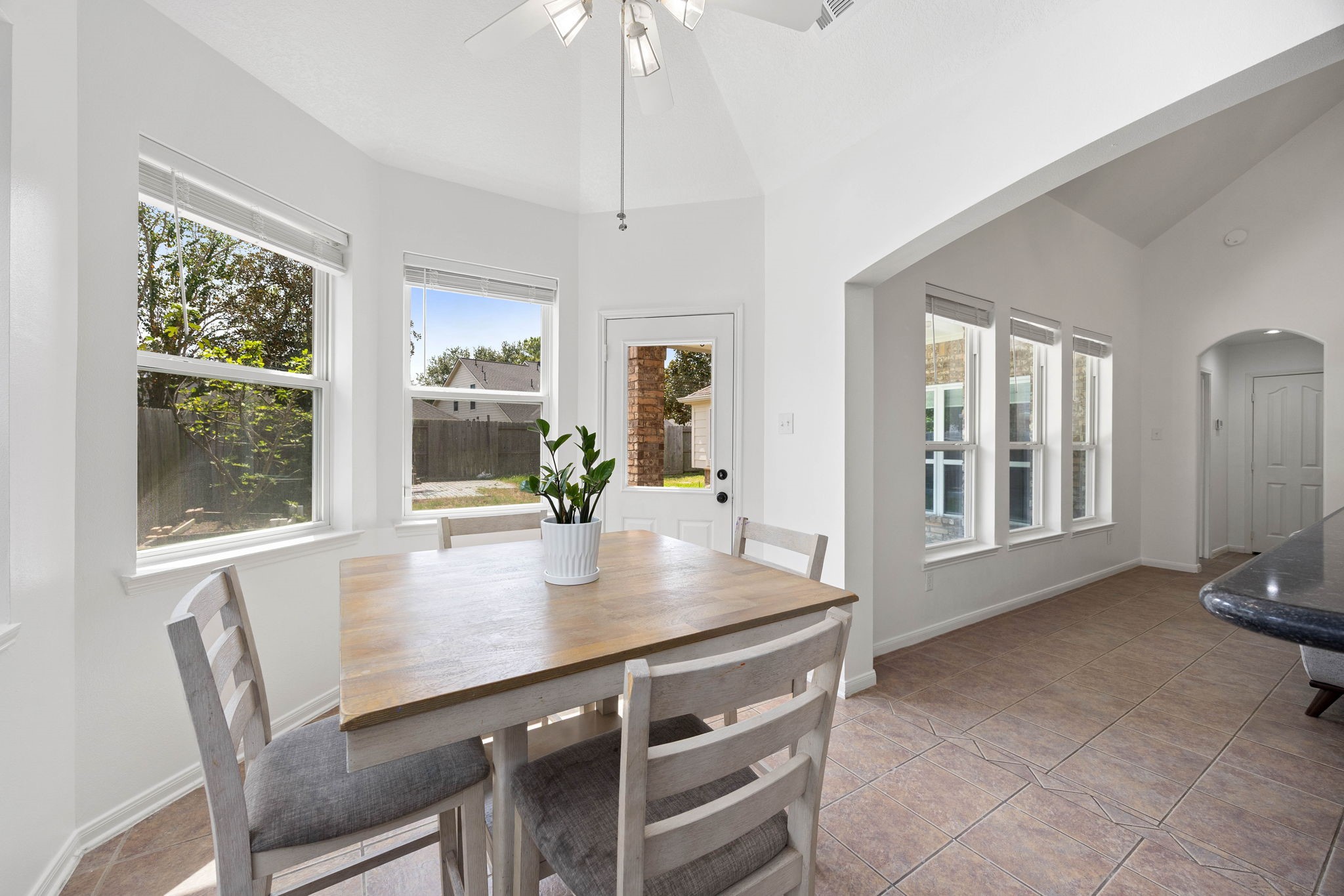 Bright breakfast area surrounded by windows and conveniently positioned between the kitchen and living space.