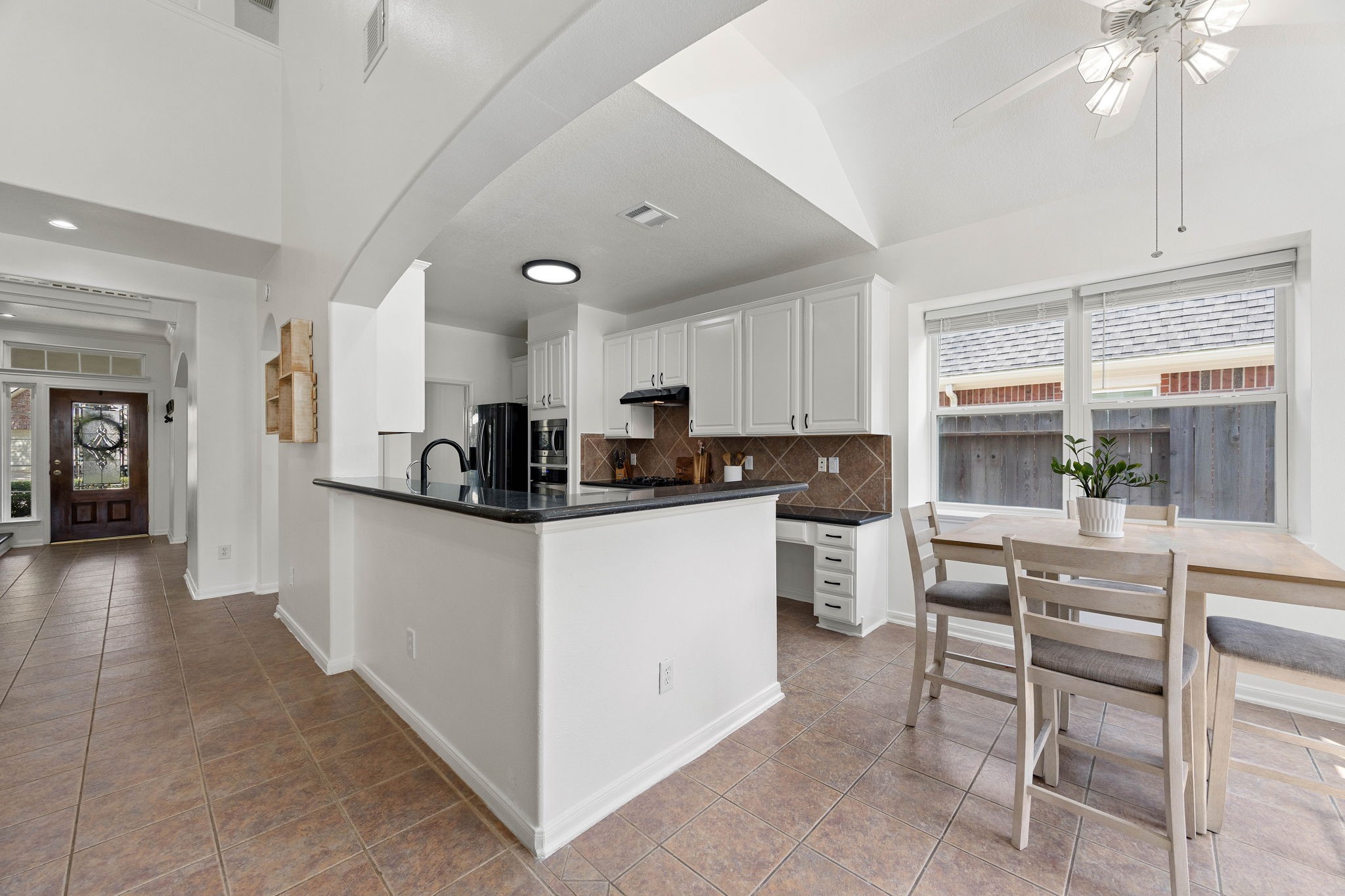 Kitchen and living area featuring a breakfast bar, ample cabinetry, and an open layout ideal for everyday living.