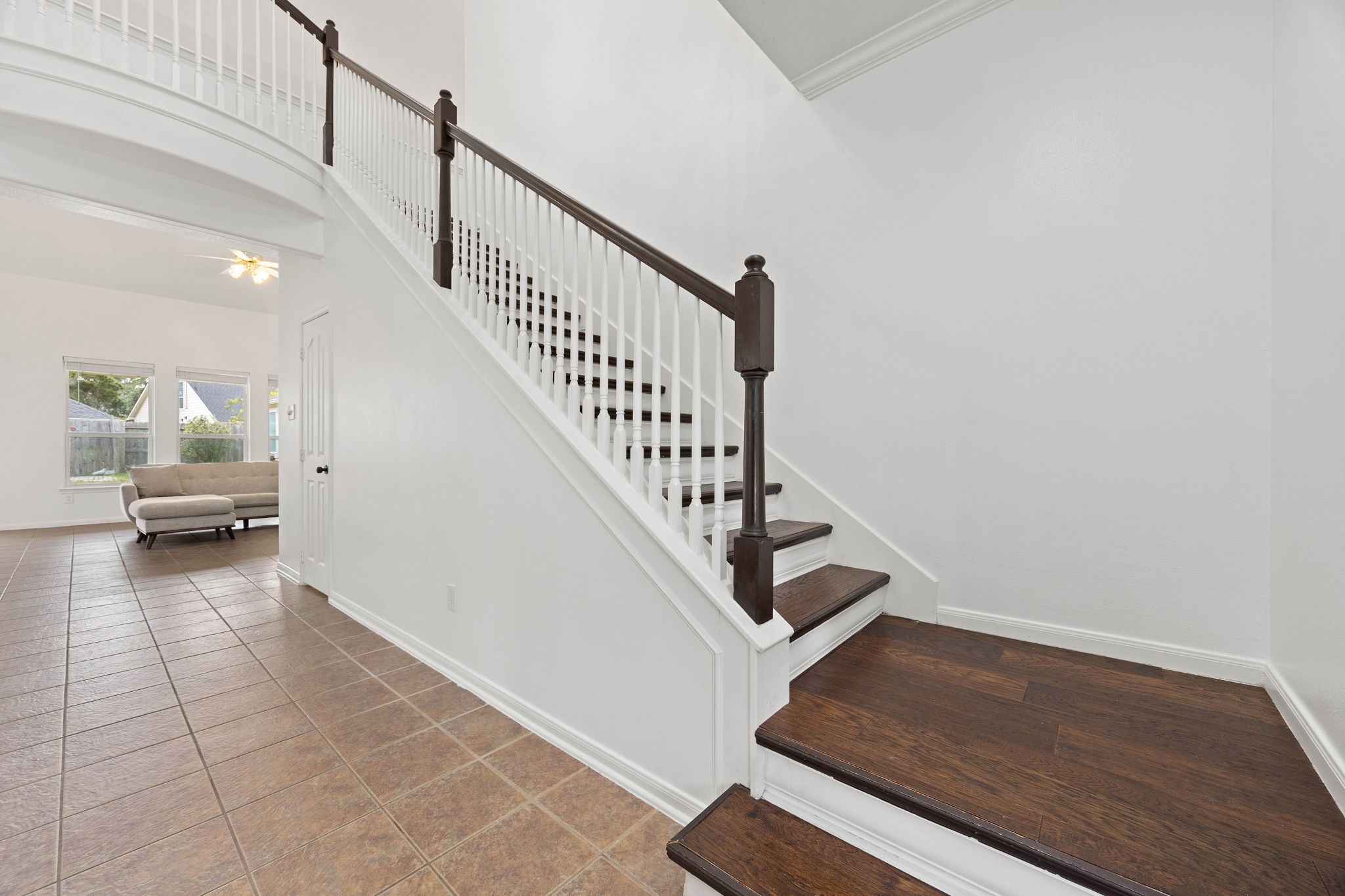 Upstairs landing and staircase featuring an open railing and a view toward the main level of the home.