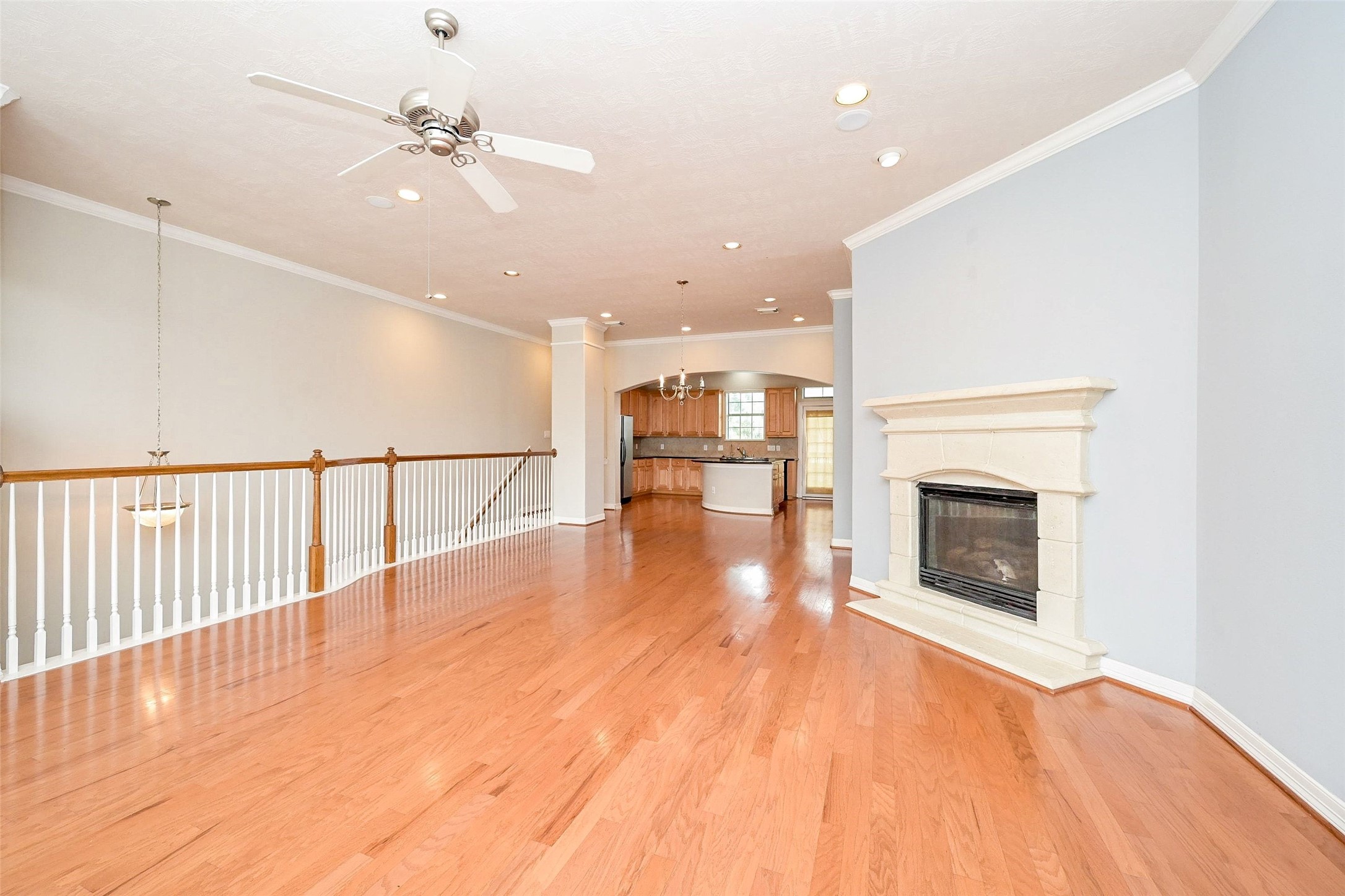 Spacious and Open Floor Plan with a Fireplace, featuring original hardwood flooring.