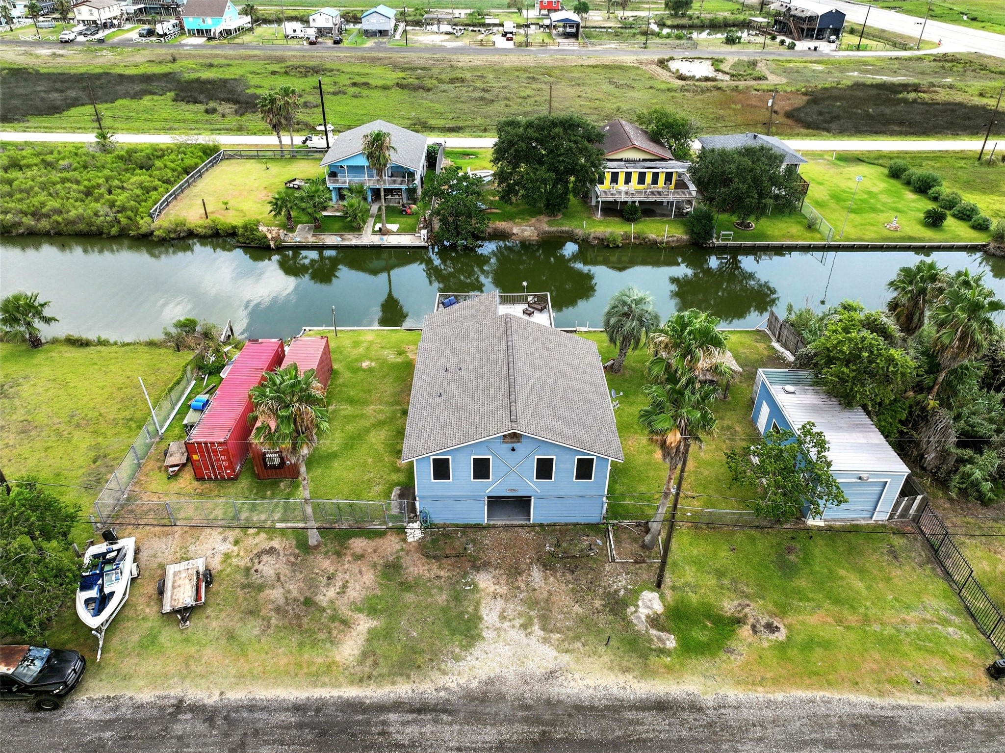 aearial view of front of home with canal in back