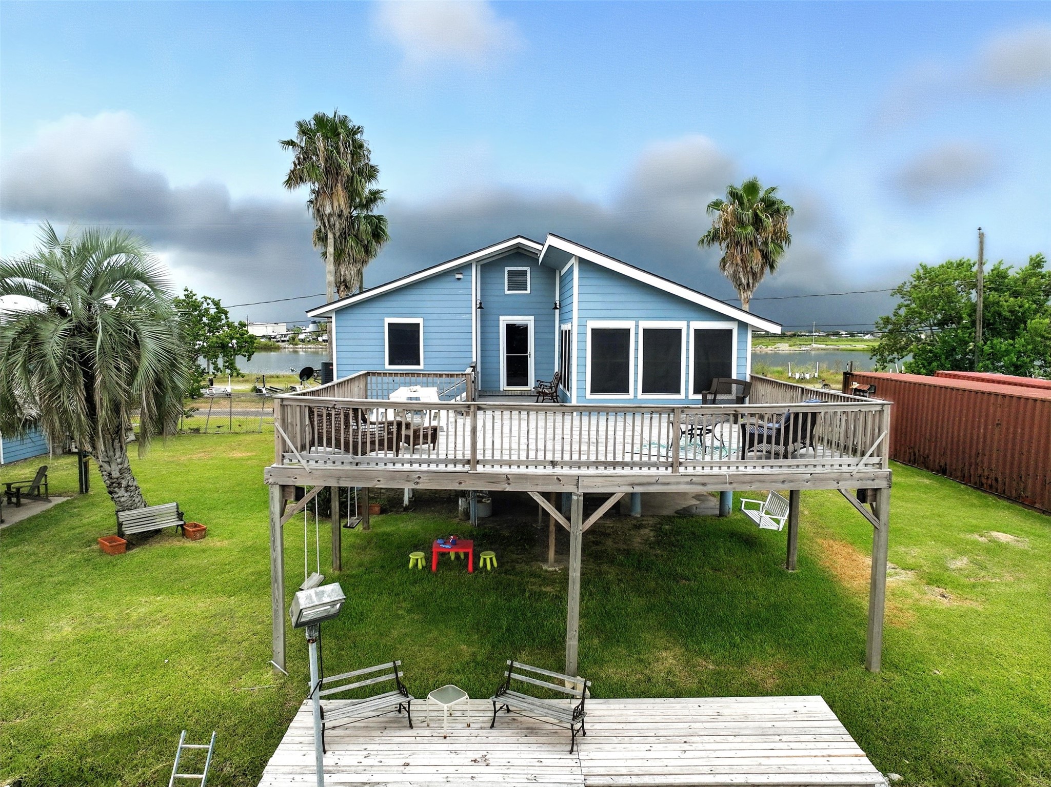 View of rear of home with upper level deck and lower dock