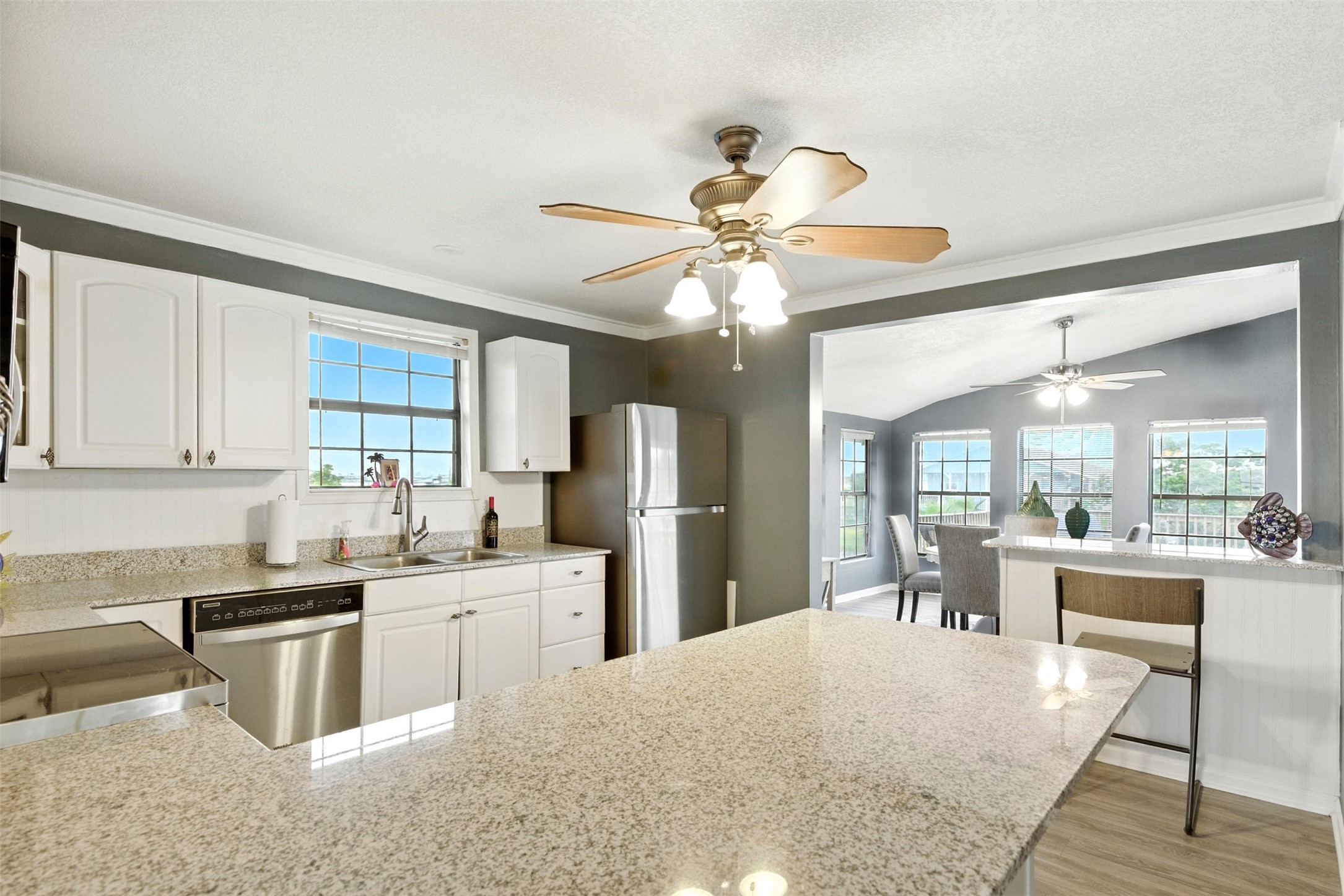 Kitchen leads to dining room with waterviews from three sides