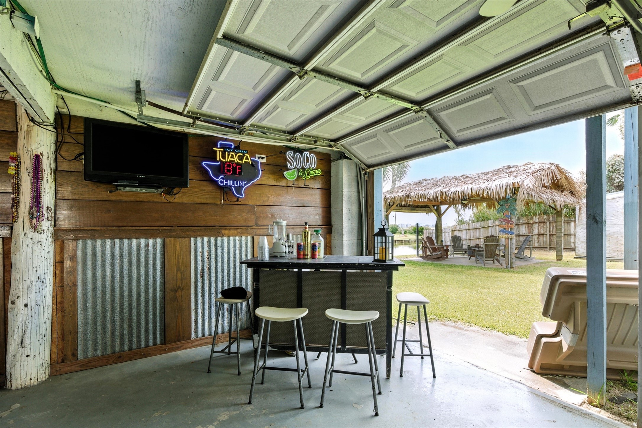 lower level space with four garage doors, bar and decor included