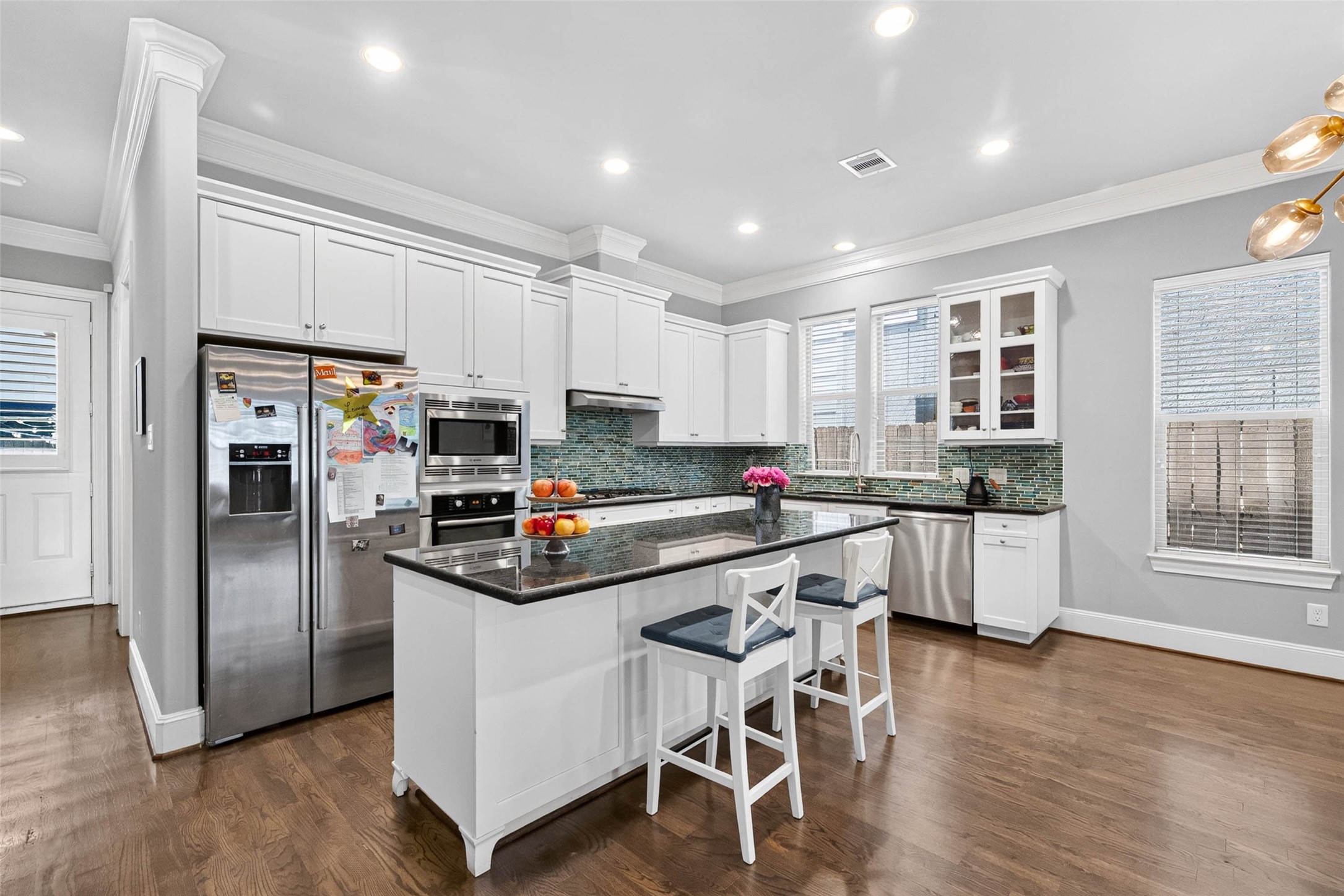 The kitchen's location at the rear of the home makes entertaining a breeze, with easy access to the backyard for dining and gathering with friends and family.