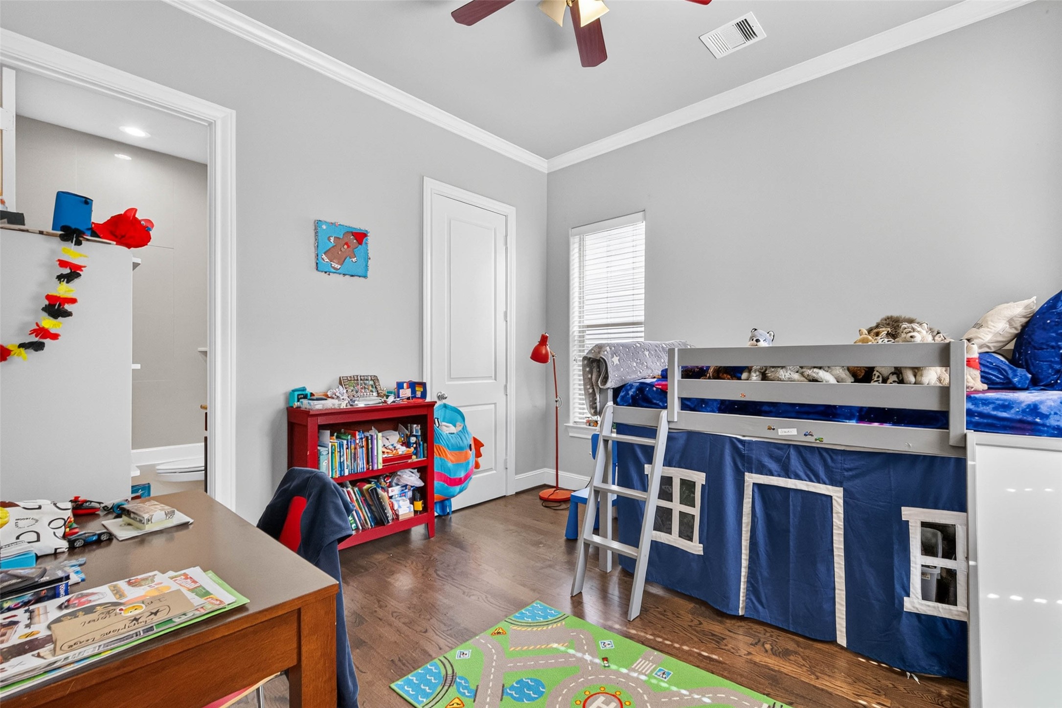 Located downstairs, this bright secondary bedroom offers abundant natural light and a private ensuite bath for added comfort and convenience.