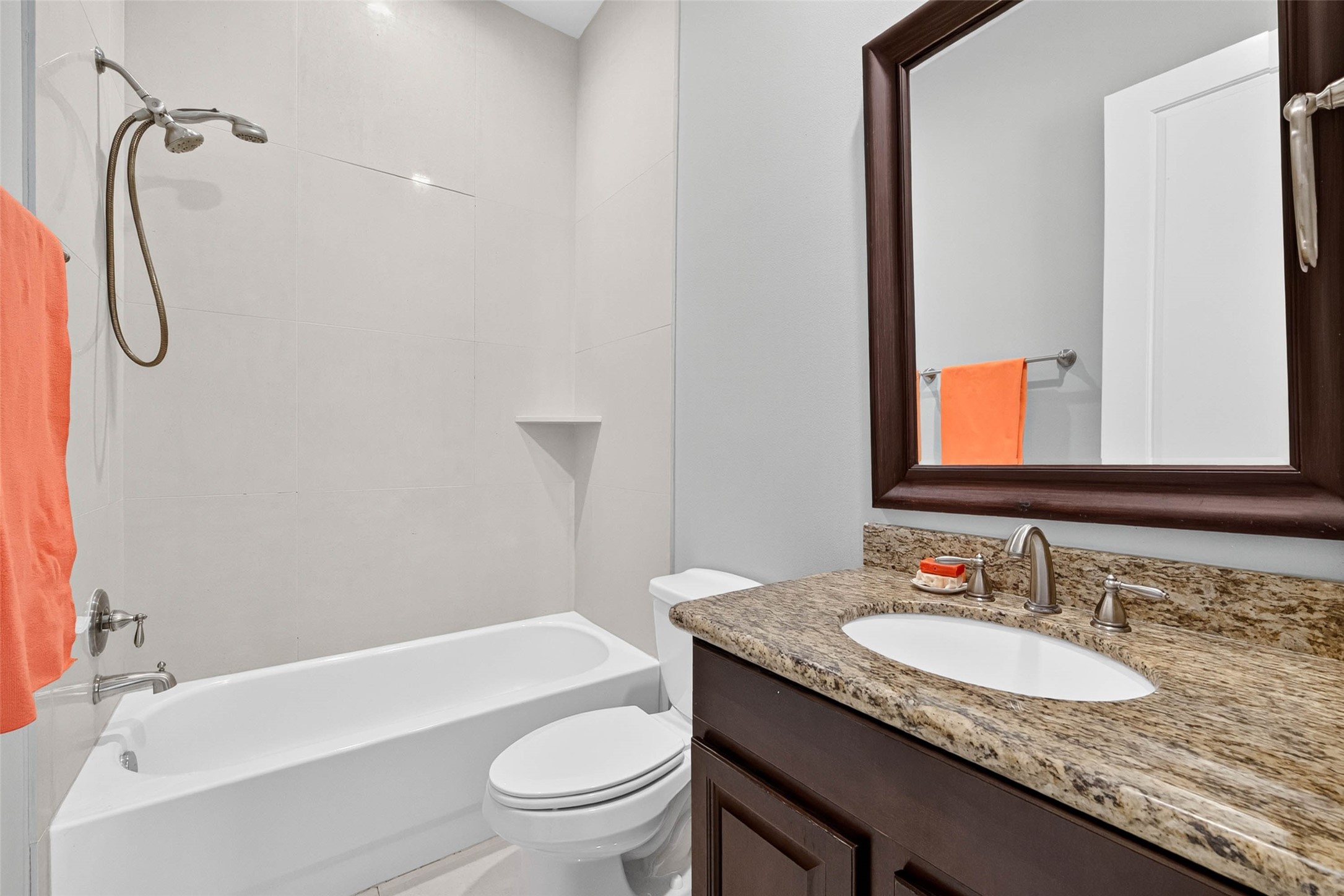 The private ensuite bath features a convenient tub and shower combination, offering a functional setup for everyday use.
