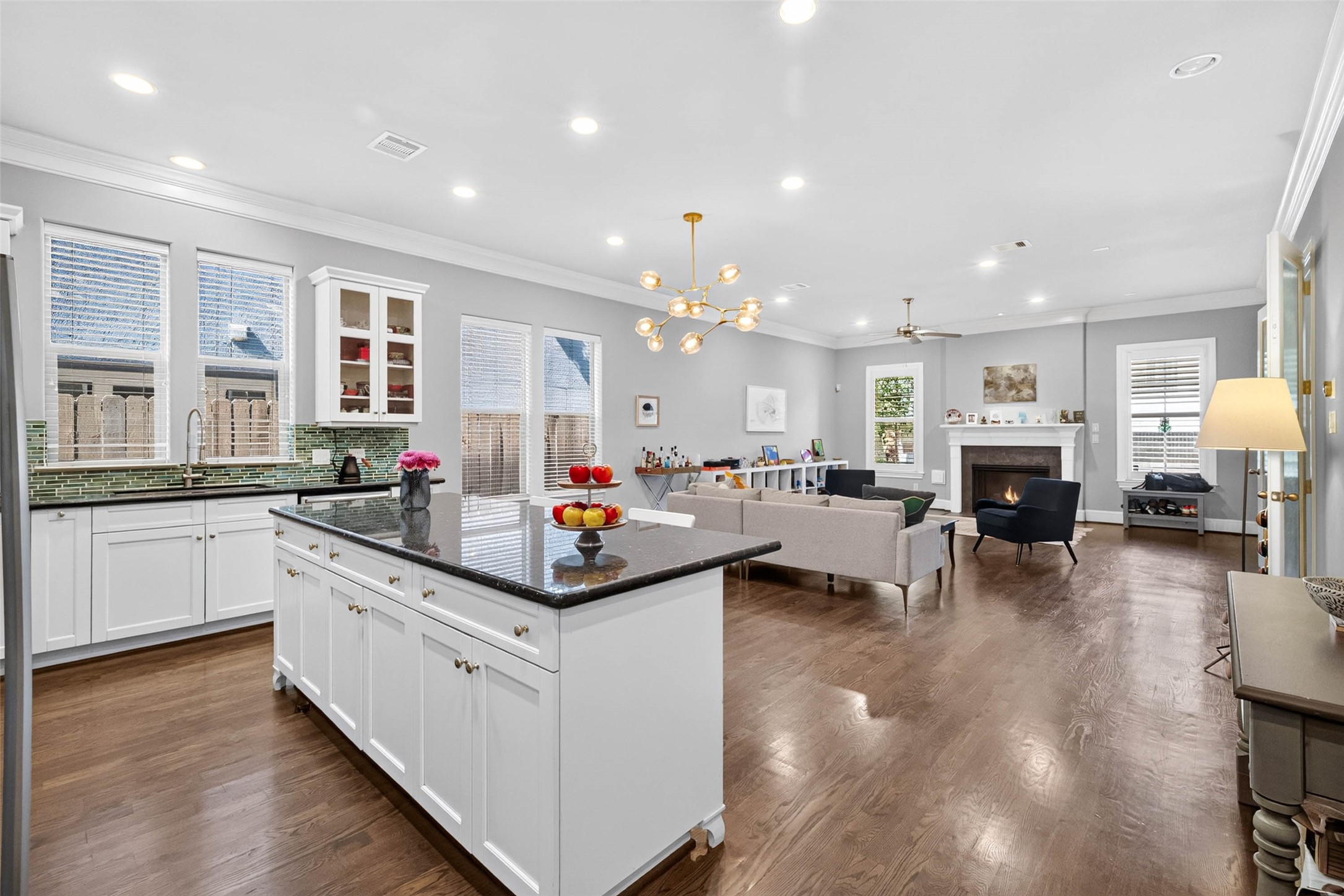 An oversized island anchors the space, offering plenty of room for meal prep, casual gathering, and everyday living.
