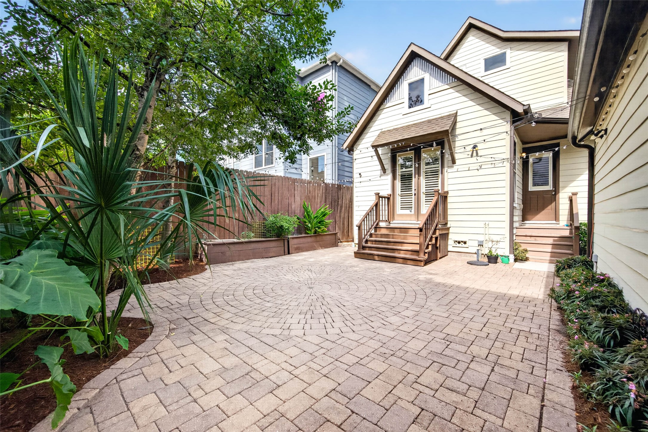 Twinkle lights and charming flower beds add a touch of whimsy.
