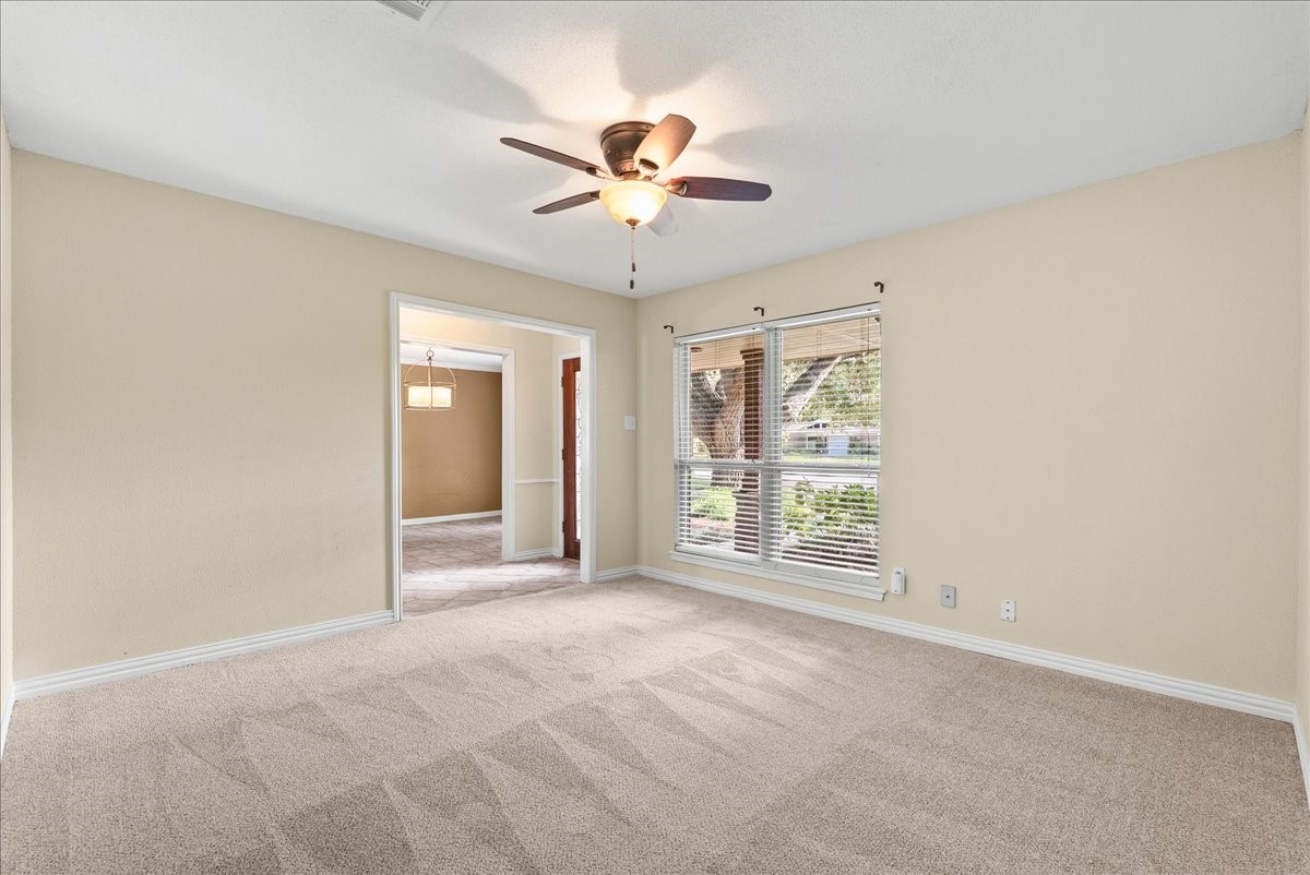 Bright, spacious flex room room perfect for a home office, game room or extra entertaining area with large windows to invite natural light