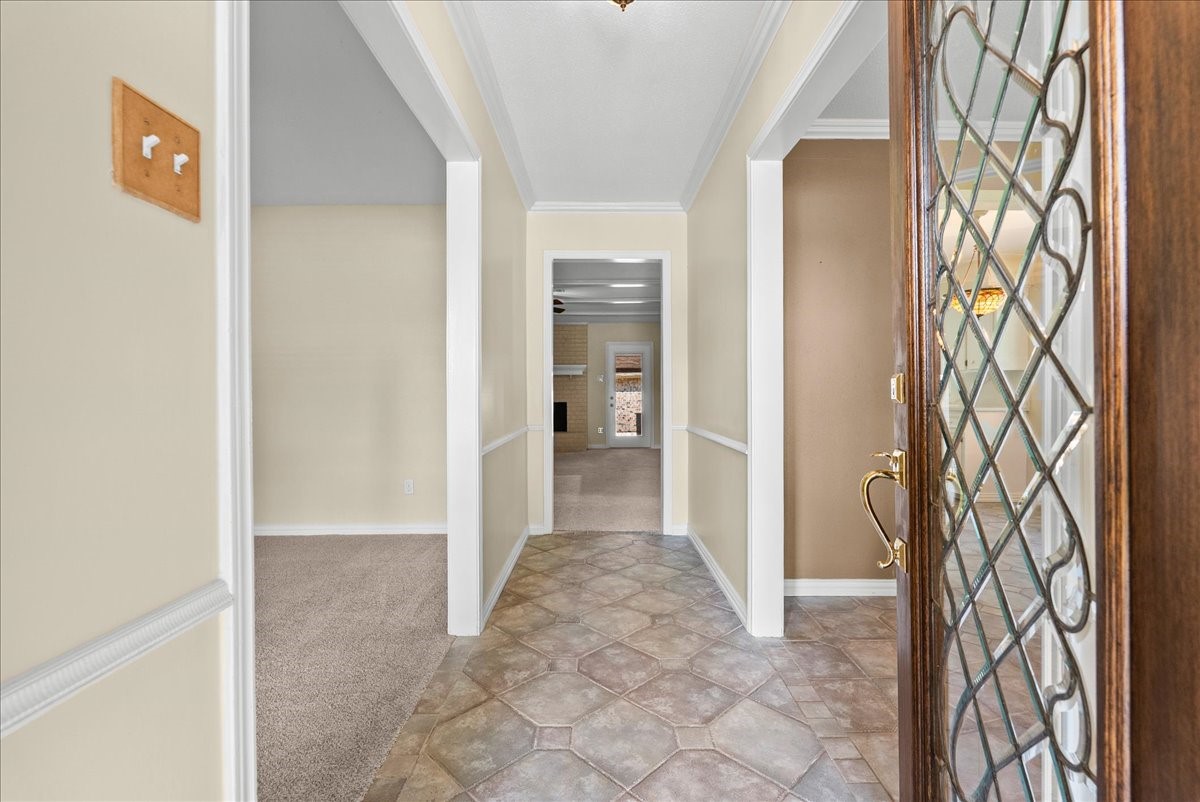Inviting foyer leading to spacious rooms and featuring a gorgeous leaded glass door.