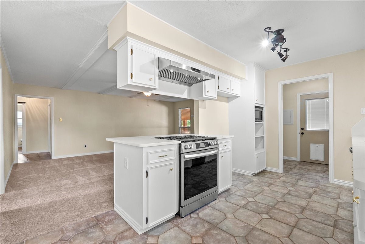 Bright kitchen with newer range and new countertops.