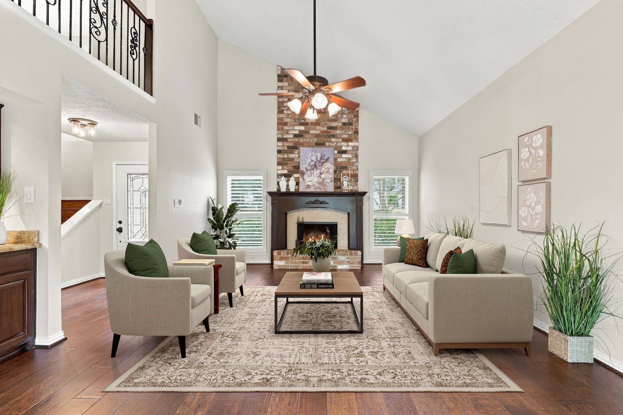 Living room featuring a beautiful wood burning fireplace, soaring ceilings, and an abundance of natural light. This home has Plantation Shutters on all windows. Virtually staged Living room featuring a beautiful wood burning fireplace, soaring ceilings, and an abundance of natural light. This home has Plantation Shutters on all windows. Virtually staged