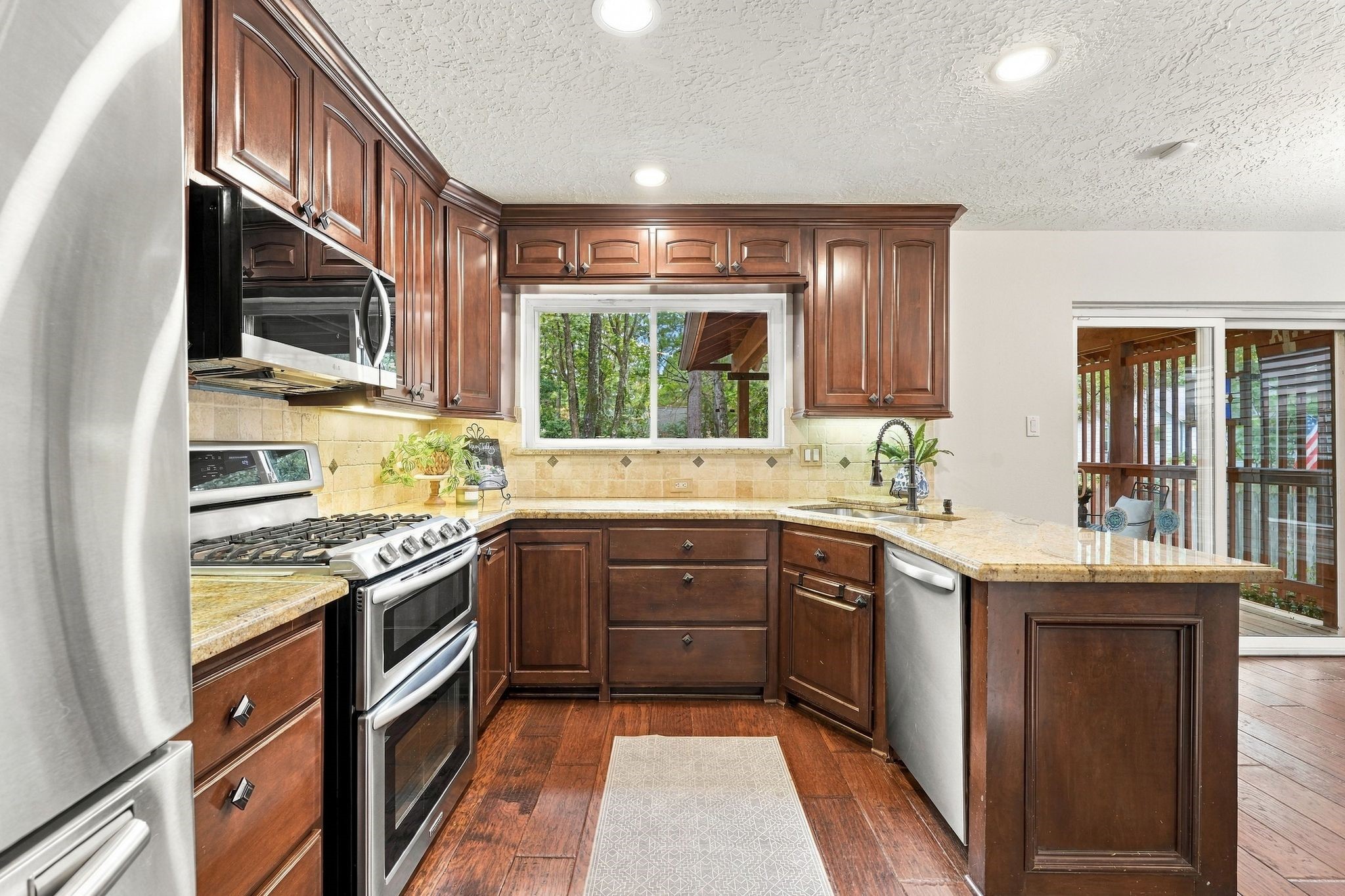 Another view of the spacious kitchen, highlighting the abundant cabinetry and natural light.