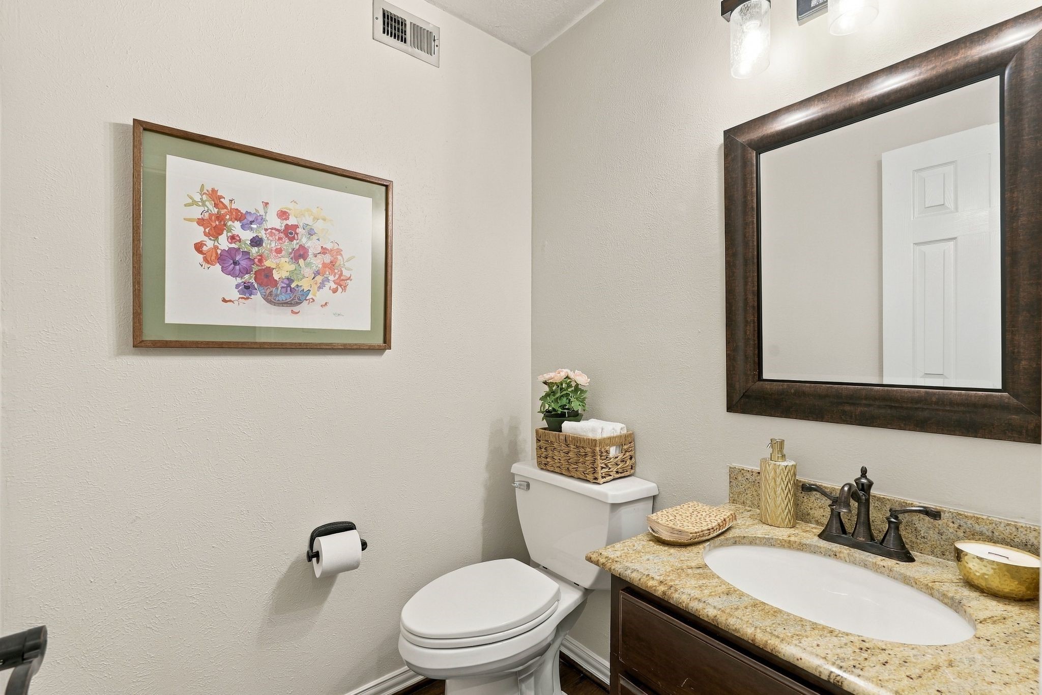 Convenient powder room featuring a spacious vanity located on first level.