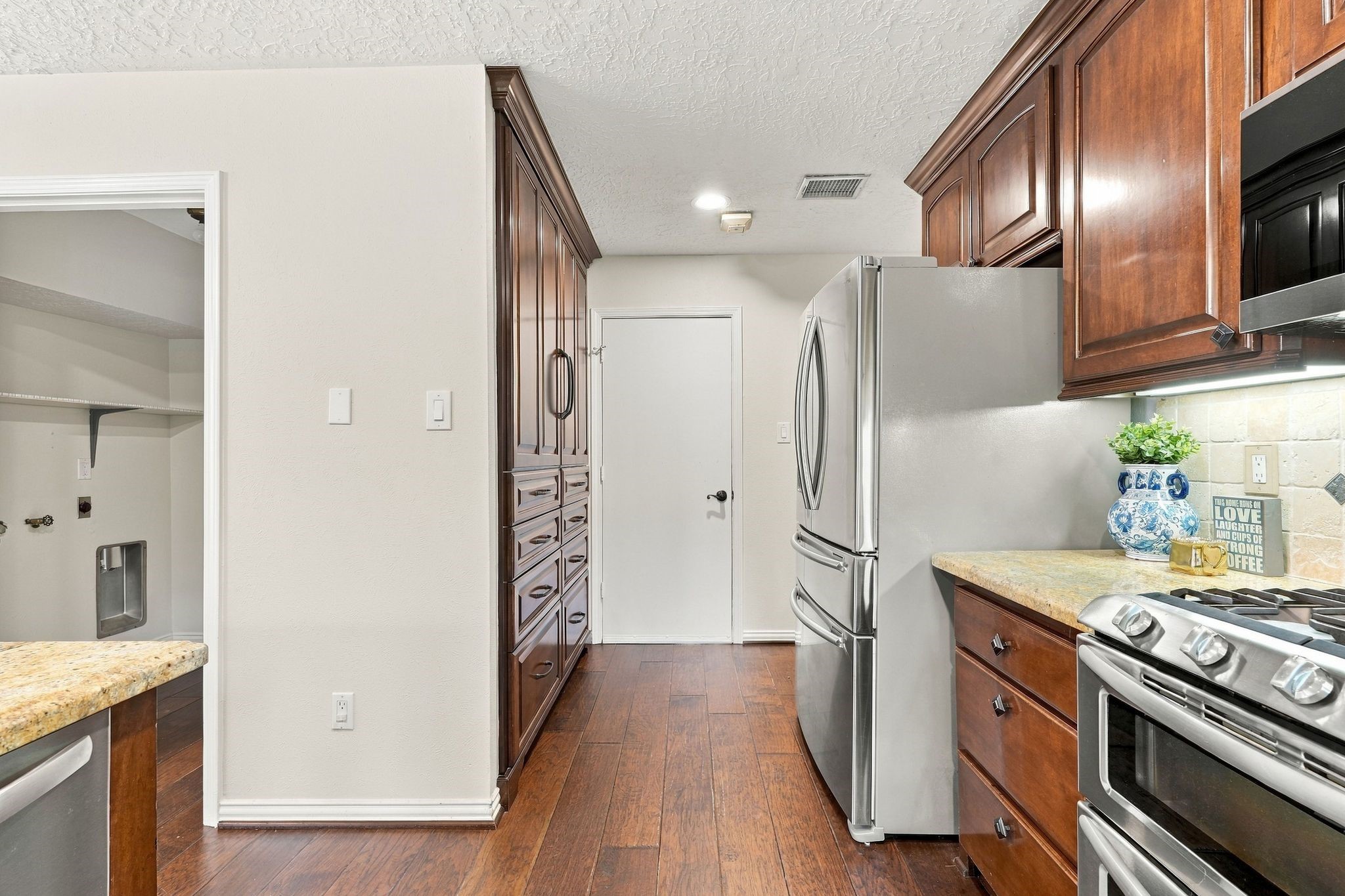 Another view of the kitchen. Laundry room on the left and garage entry straight ahead.