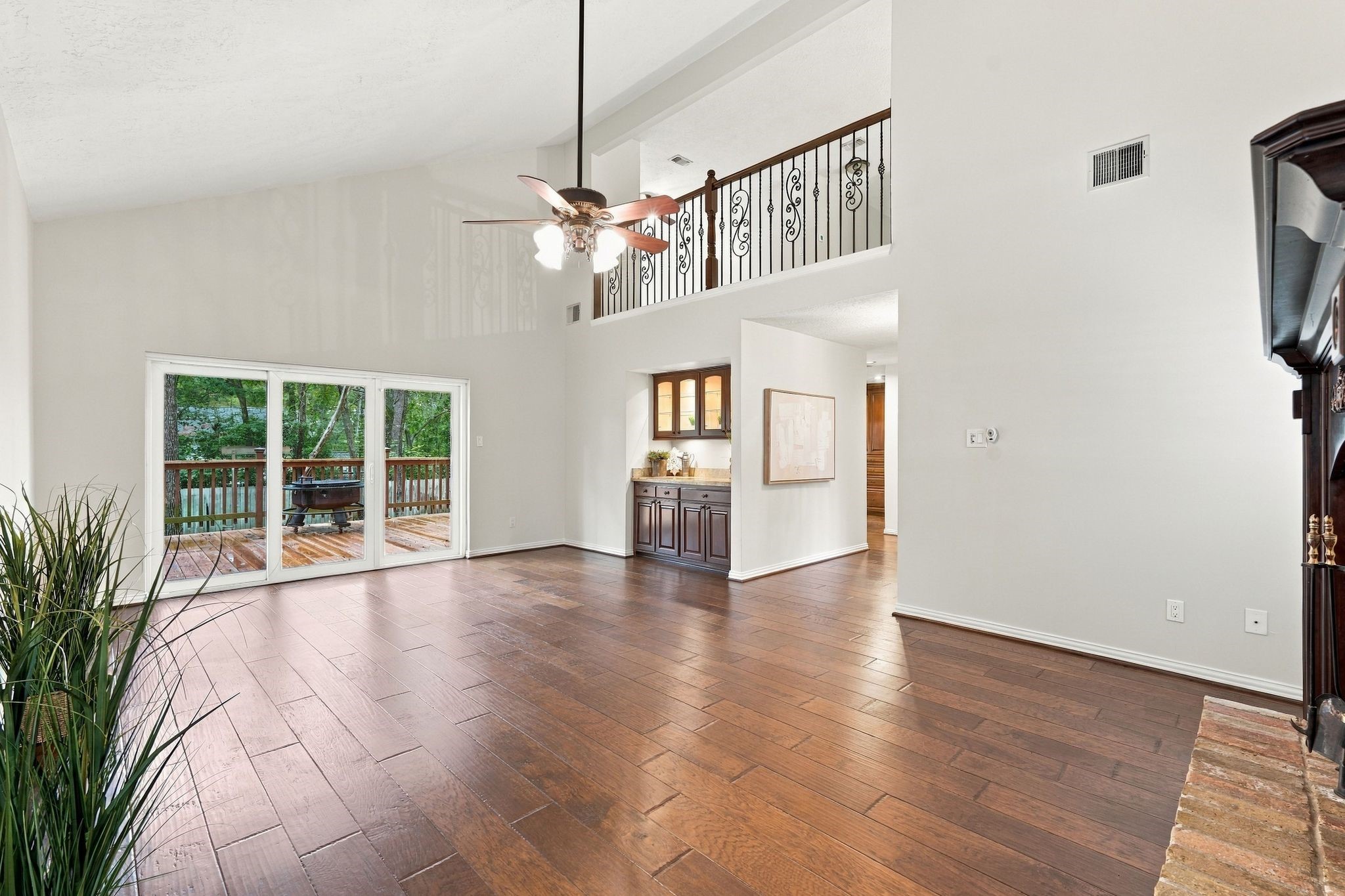 Spacious living area with high ceilings and an open layout perfect for entertaining. The sliding patio doors lead out to the brand new deck that overloooks the back yard. Spacious living area with high ceilings and an open layout perfect for entertaining. The sliding patio doors lead out to the brand new deck that overloooks the back yard.