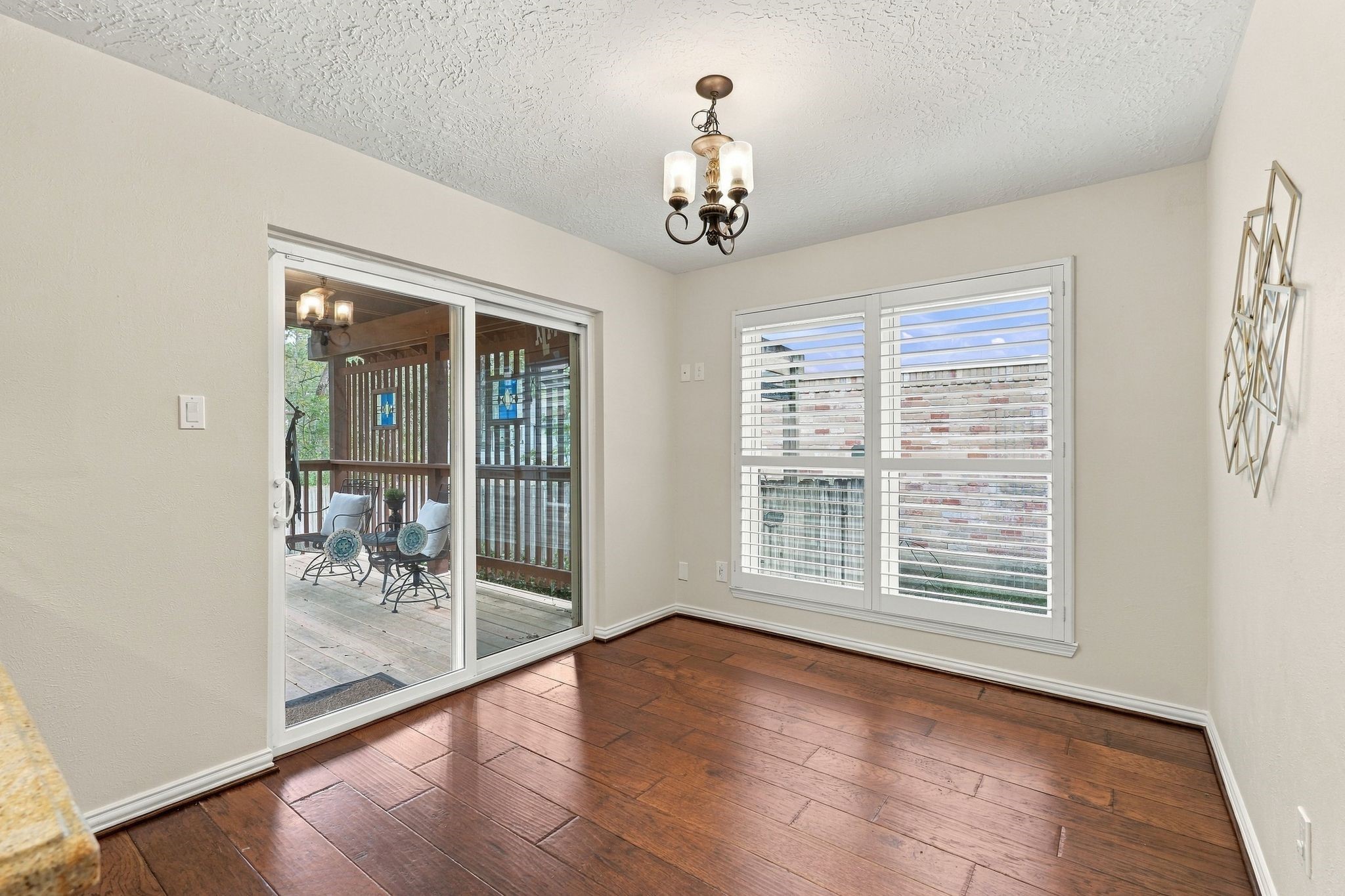 Bright dining area featuring large windows and easy access to the covered deck and outdoor space.