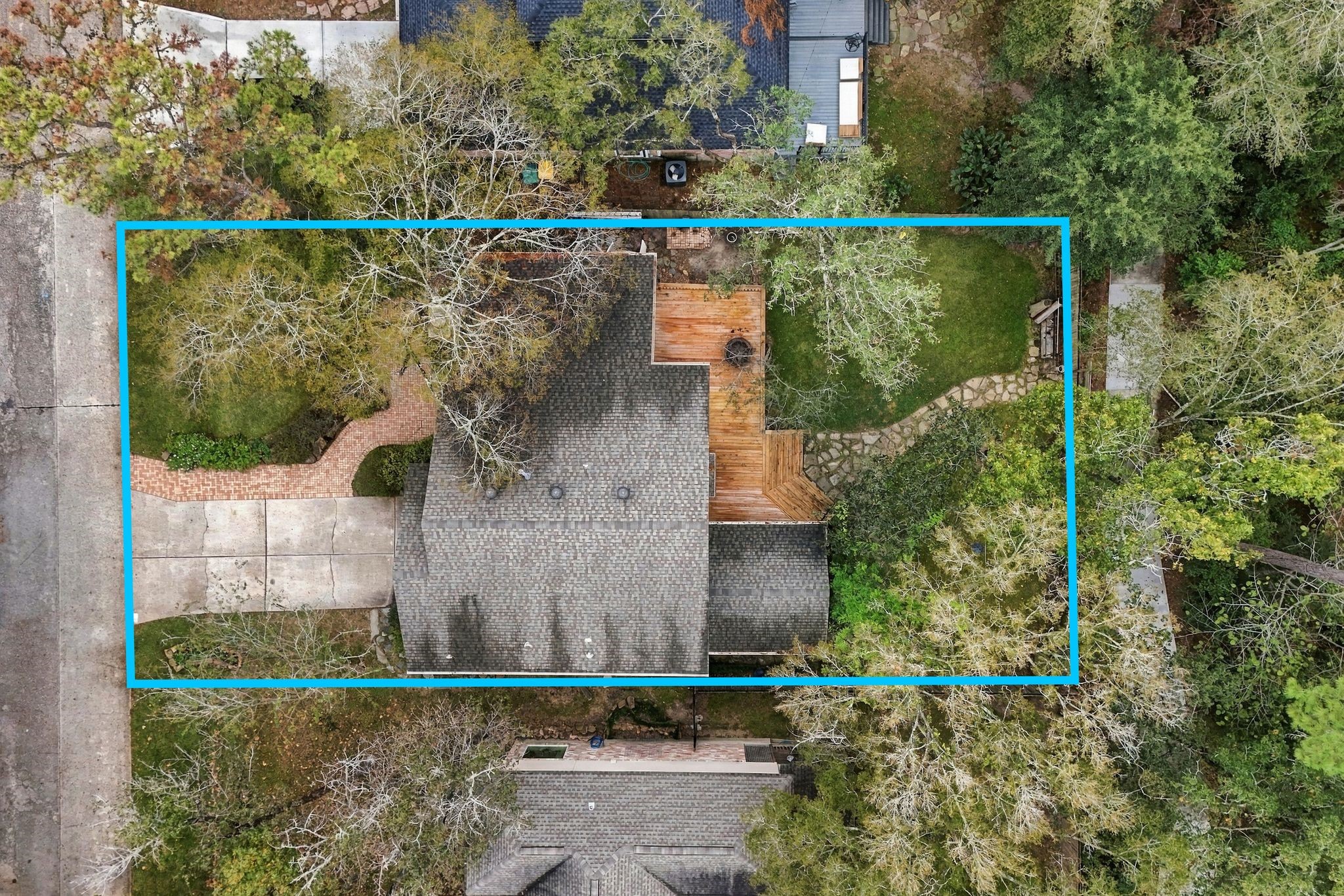 Aerial view highlighting the property's layout, mature trees, and surrounding outdoor space.