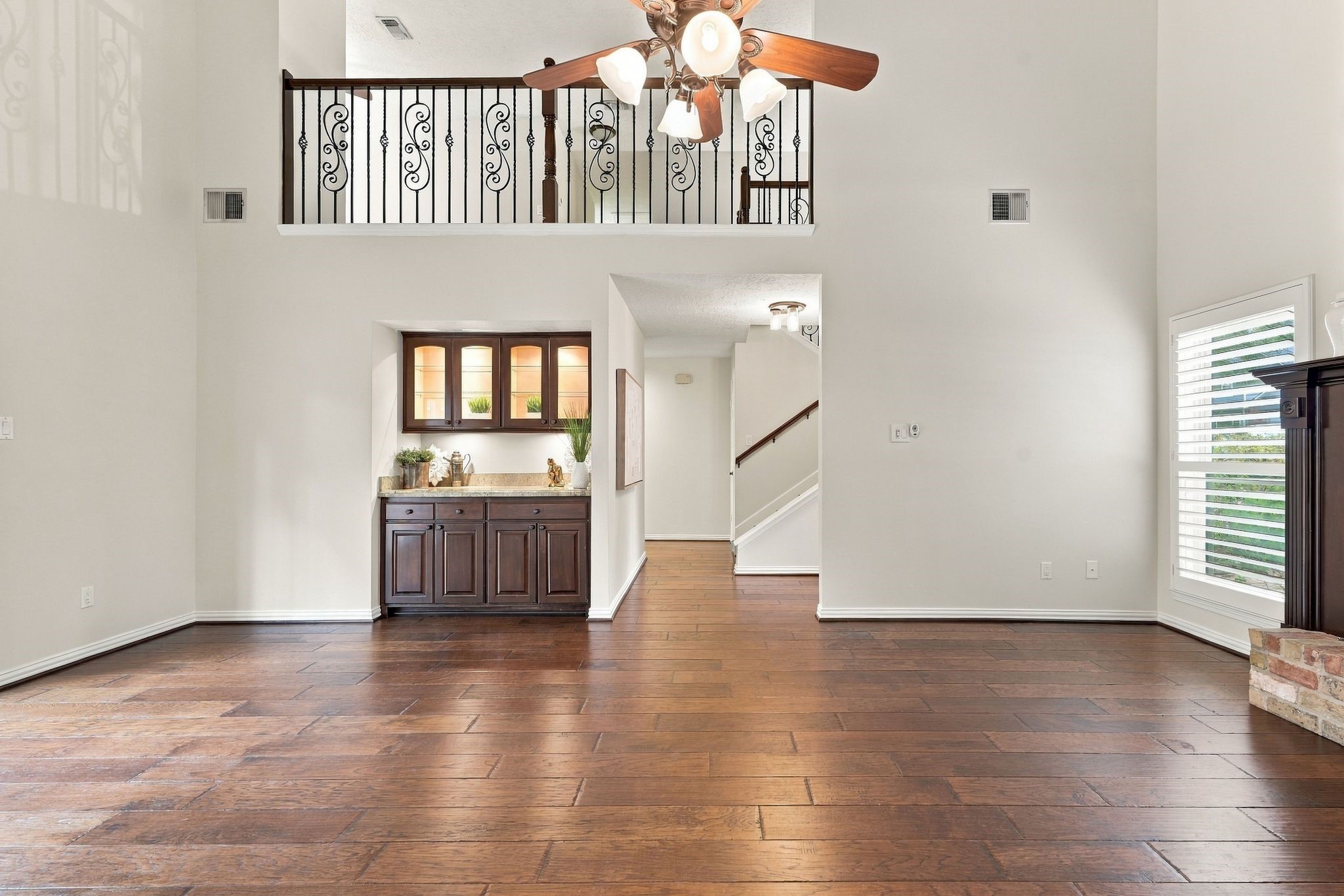 Another angle of the living area, showcasing the open layout and elegant architectural details. Dry Bar ready for entertaining.