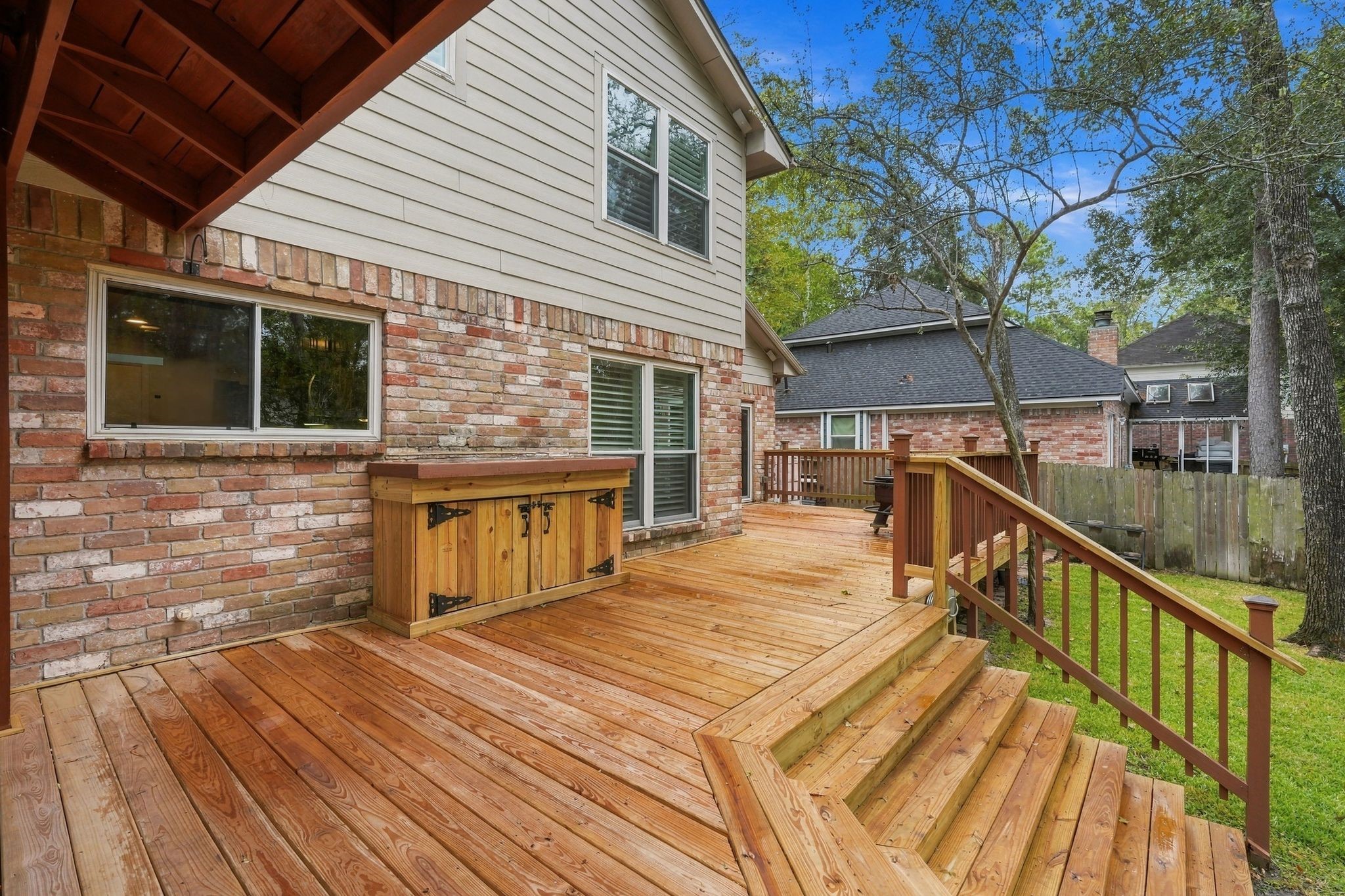 Expansive wooden deck offering plenty of room for outdoor gatherings and enjoying the backyard views. Deck was just recently installed.